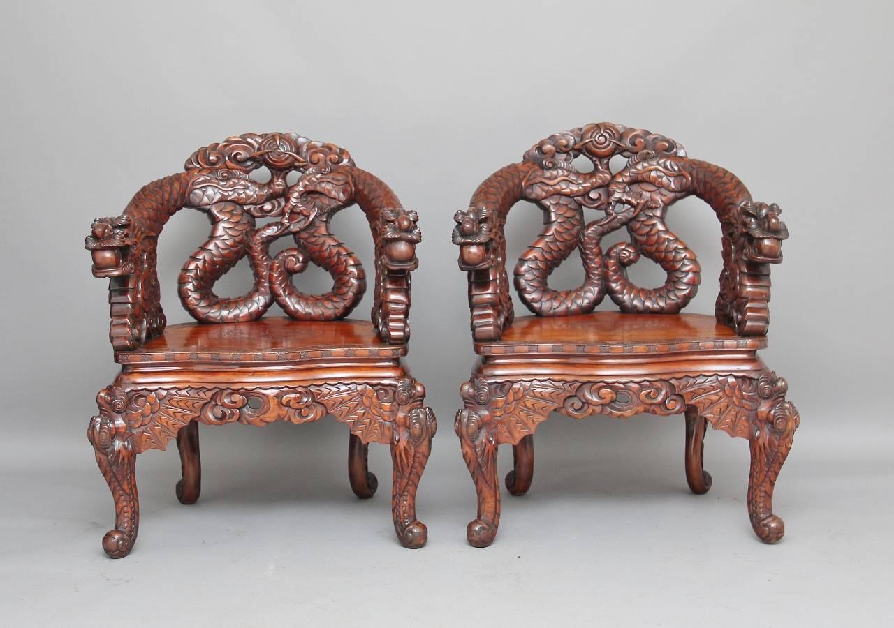 A fabulous pair of early 20th century Chinese armchairs, the back and arms are carved as dragons, standing on carved cabriole legs, these are fantastically carved all-over, lovely color too, circa 1910.
 
