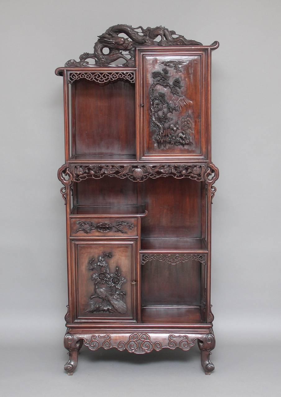 A fabulous quality 19th century Chinese cabinet, a cupboard each at the top and bottom with workable locks, with a single drawer in the centre, with very fine carved details on the panels and doors, lovely colour, all in excellent condition, a very