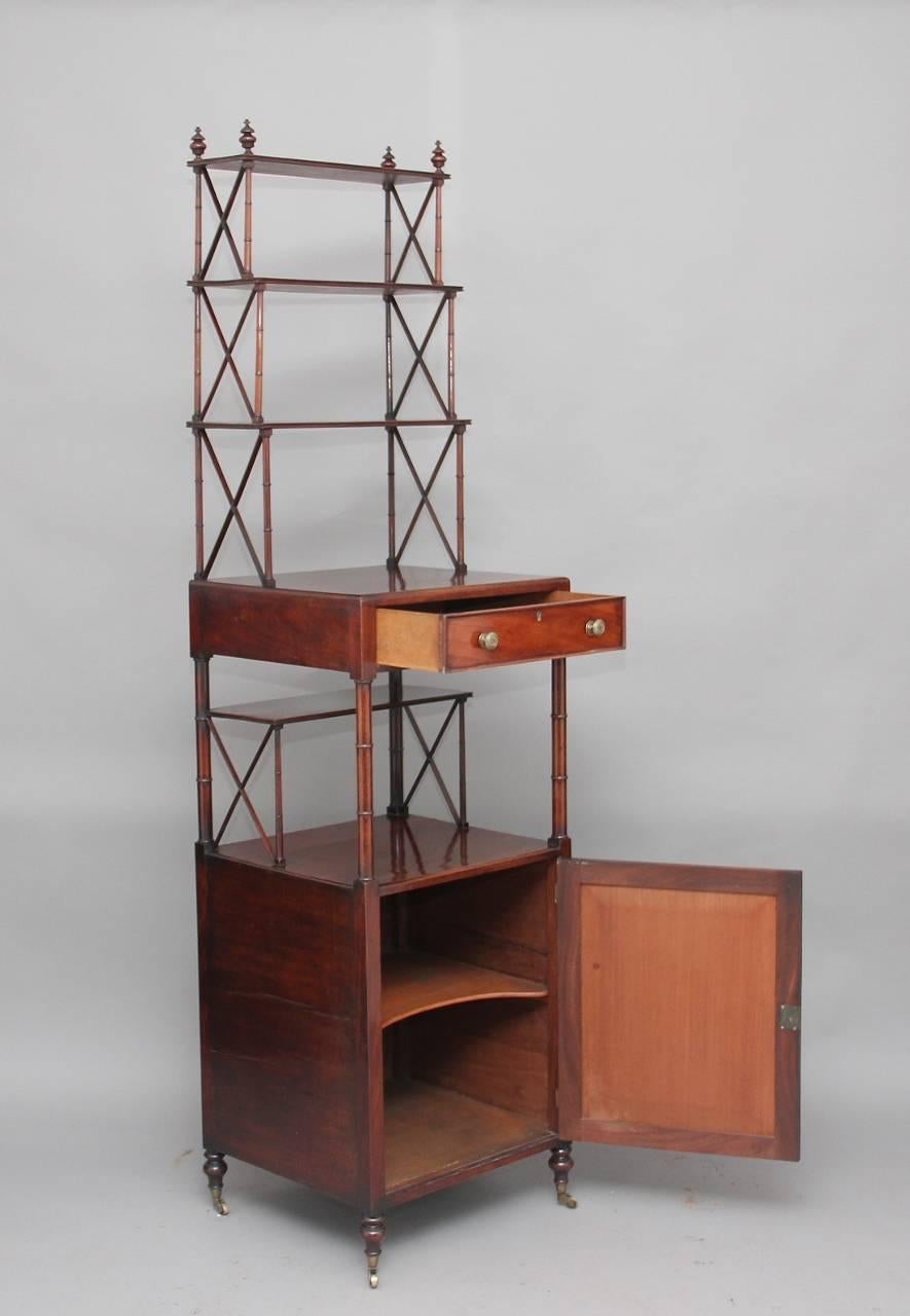 An unusual and rare 19th century mahogany whatnot, the top structure having four turned finials with three shelves below with turned supports and trellis design, with a single oak lined drawer below with original turned knobs, with a cupboard below