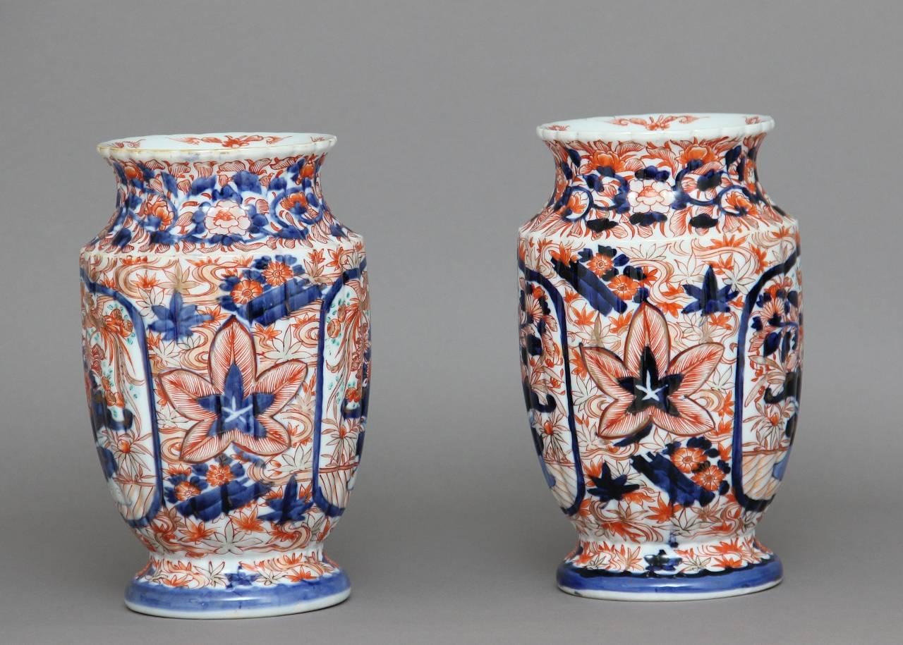 A decorative pair of Japanese 19th century Imari porcelain vases of good proportions, decorated throughout with red and blue glazes on a white ground, the vases showing exotic birds, flowers and foliage, circa 1880.
 