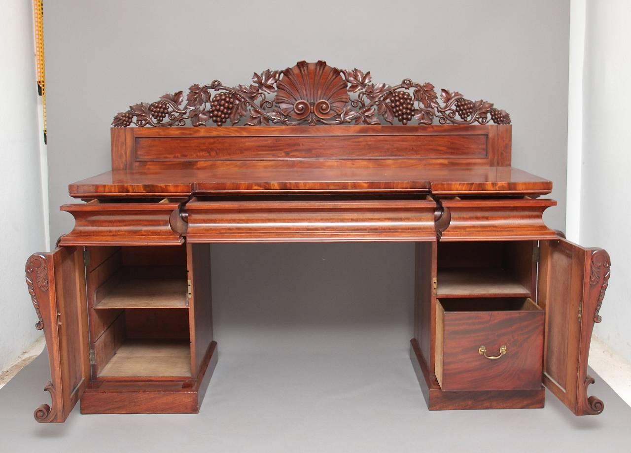 19th century mahogany pedestal sideboard, the shell and fruiting vine carved back above three frieze drawers, standing on acanthus and scroll carved twin pedestal bases with cupboards, fantastic quality, circa 1840.