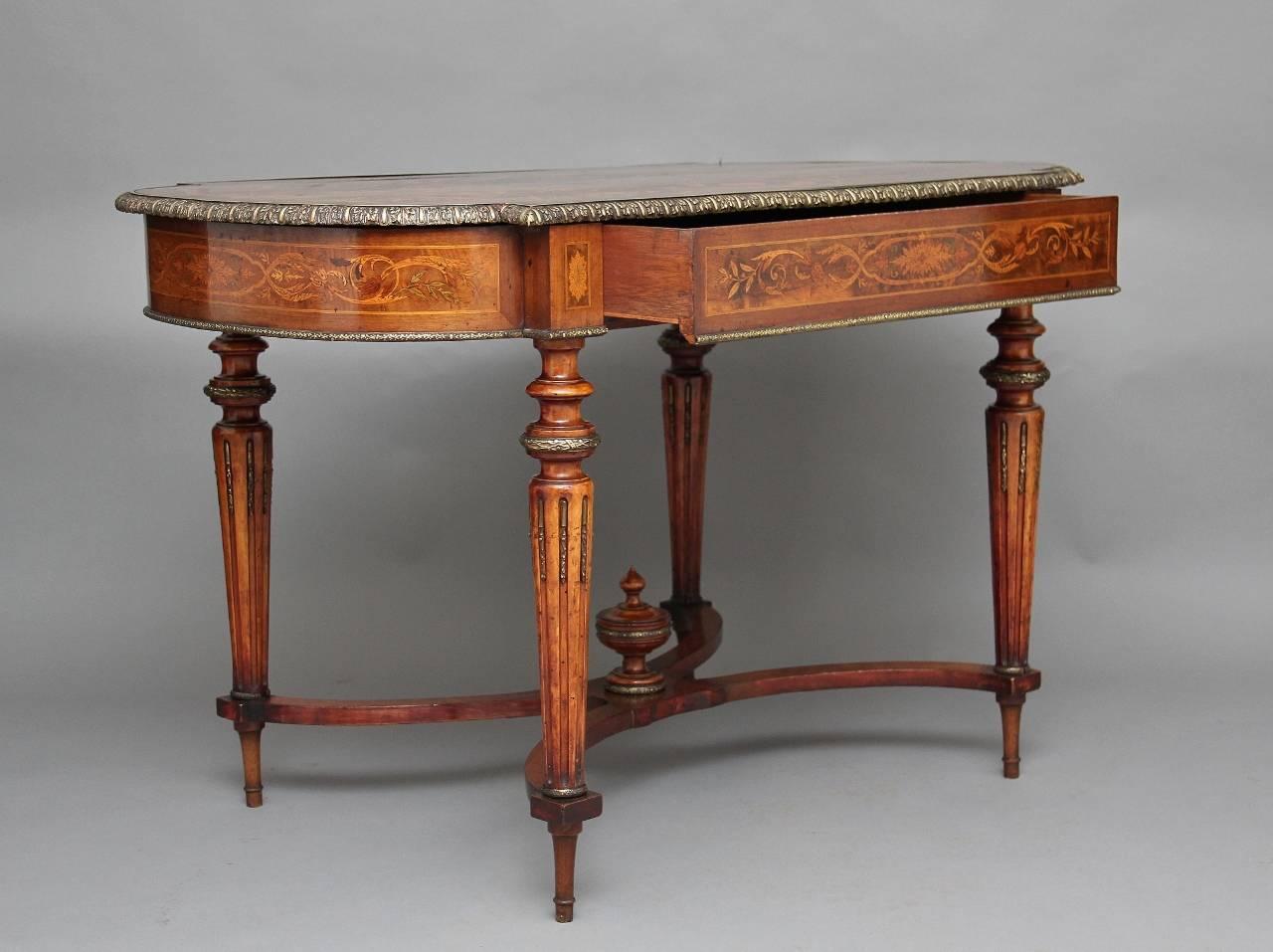 19th century French inlaid walnut center table, the shaped top profusely inlaid with floral marquetry and other designs, the top finished off with a very good quality brass moulding along the edge, with a single drawer below at the front and also