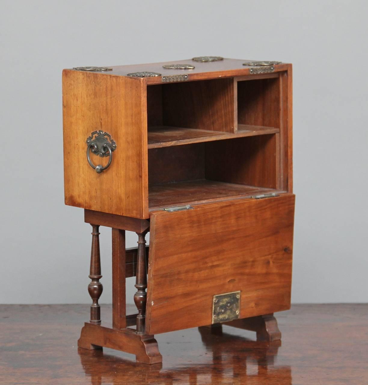 19th century Spanish miniature walnut vargueno on stand decorated with white metal fittings, opening to reveal various compartments, the lovely shaped base with turned spindle supports standing on block feet, circa 1880.