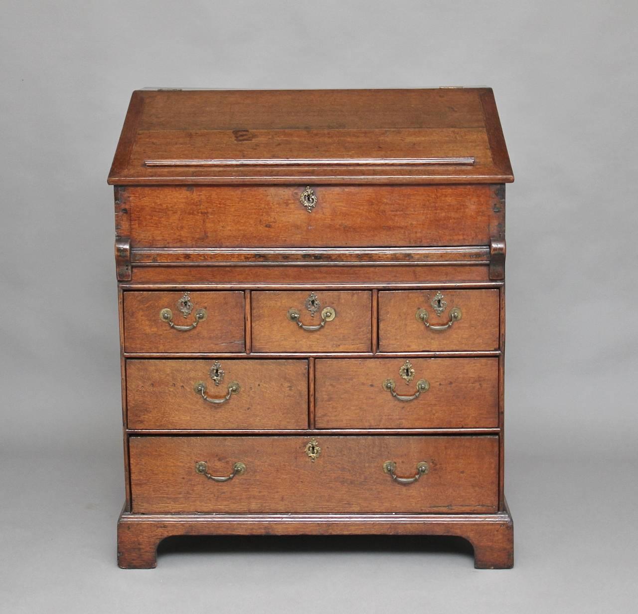 18th century oak maitre' d stand / desk with the hinged top opening to reveal a nice fitted interior with various small oak lined drawers and compartments, the front of the desk having a pull out slide with a green leather writing surface decorated