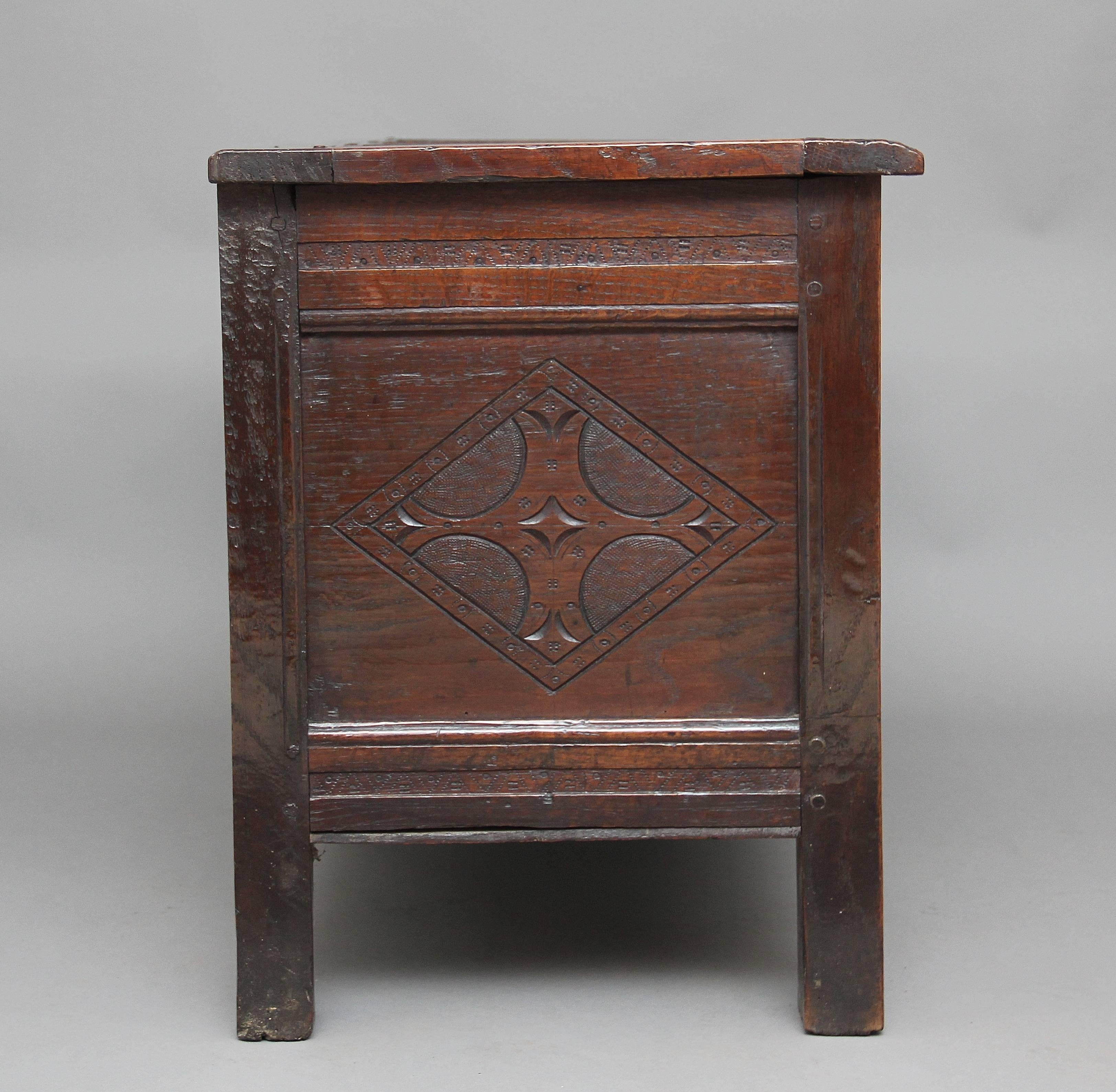 17th century oak coffer with the hinged three panelled top above a two panelled front, the side and front panels having a lovely carved pattern with the front of the coffer profusely carved all over, standing on square legs, circa 1680.
    