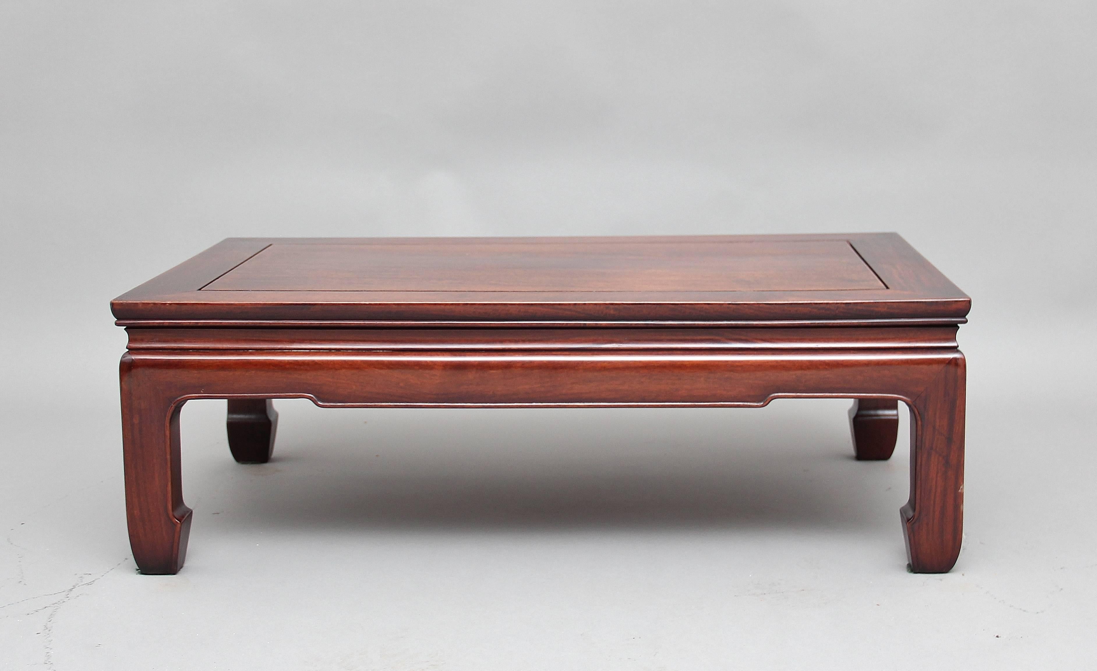 19th century rosewood Chinese coffee table, the stepped moulded rectangular top with a shaped frieze below with bead decoration supported on square and shaped legs, circa 1880.
 
