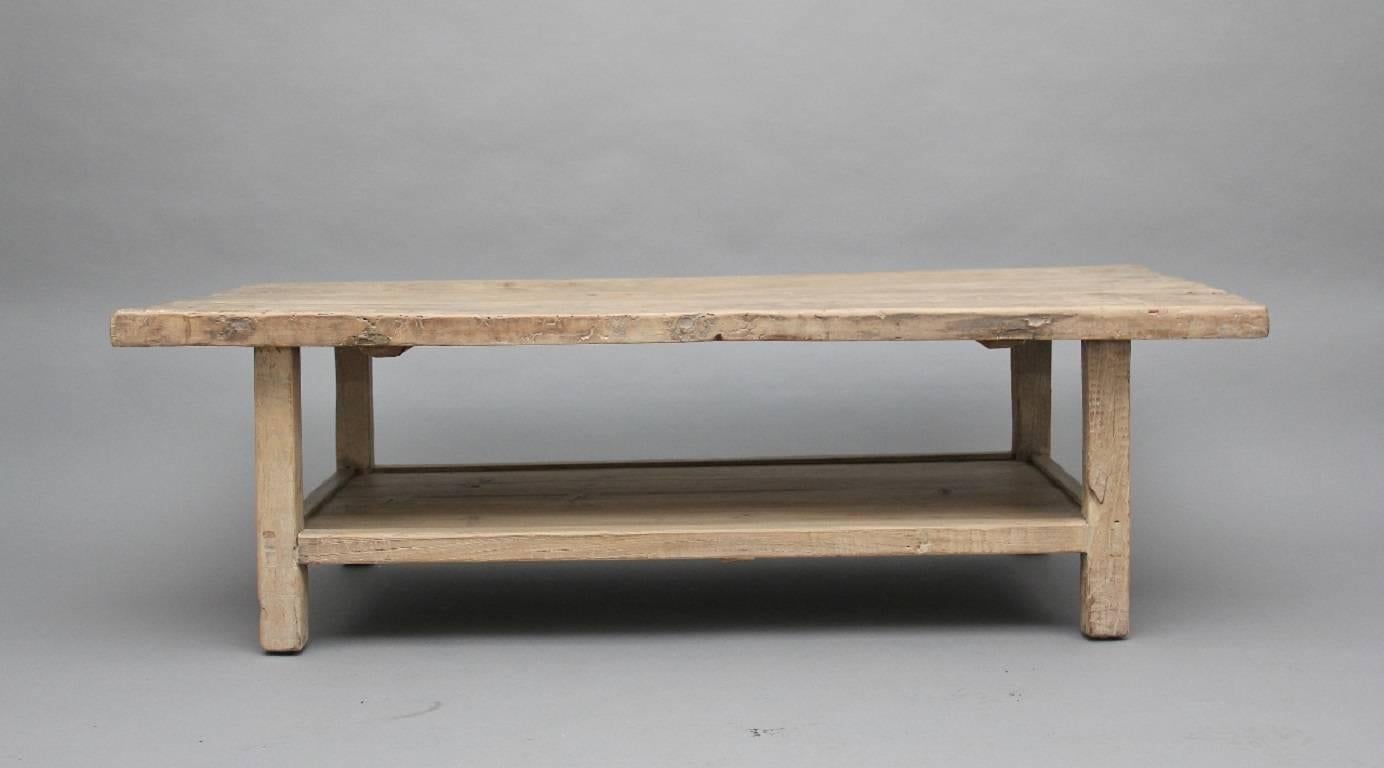 A mid-20th century Chinese rustic coffee table made up from reclaimed Chinese hardwood, the rectangular rustic top supported by four square legs united by a potboard, circa 1960.