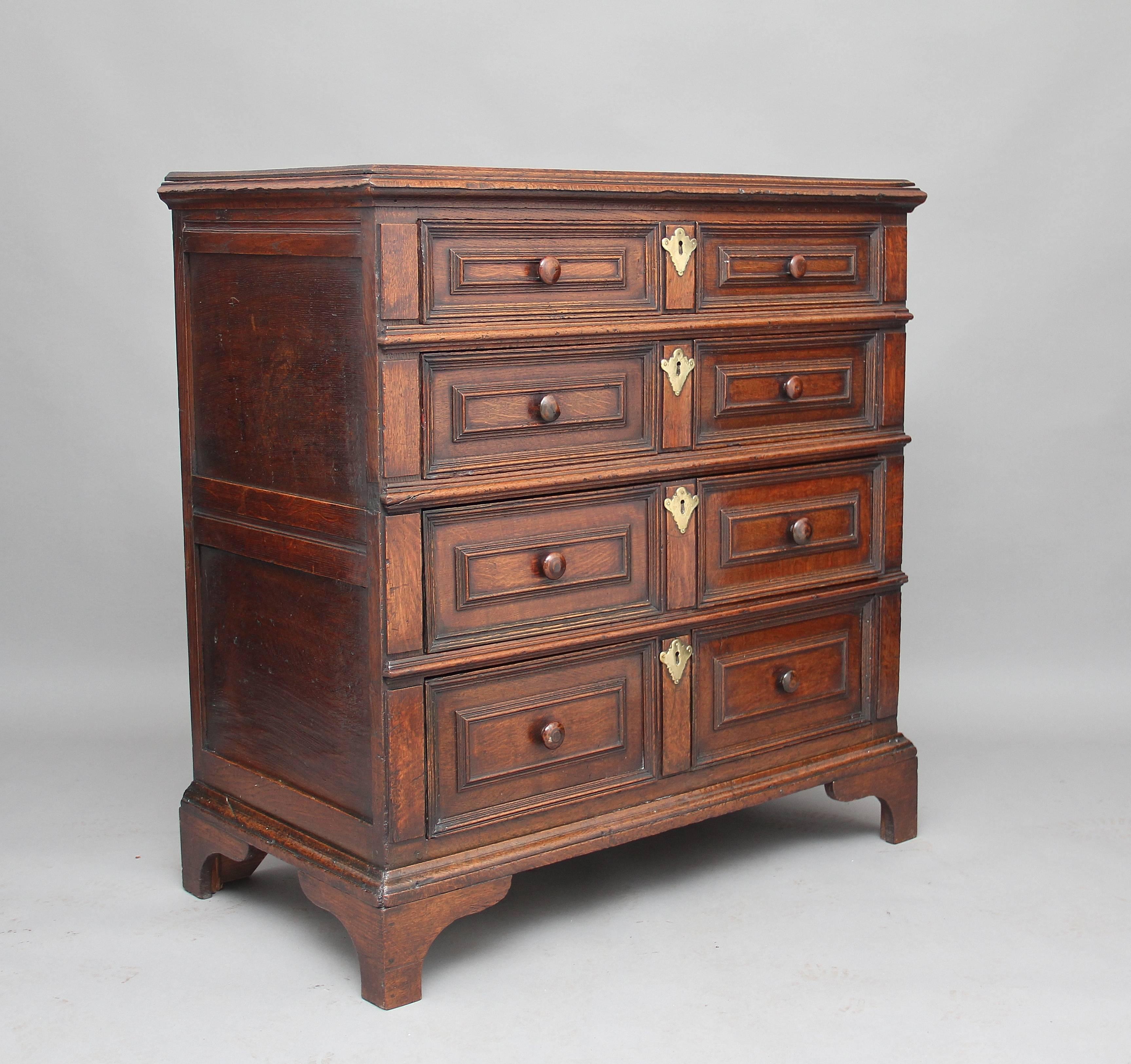 17th century oak chest with four long graduated oak lined drawers with moulded fronts, standing on bracket feet, the chest has paneled ends and is has lovely nut brown color, fantastic condition, circa 1680.
 