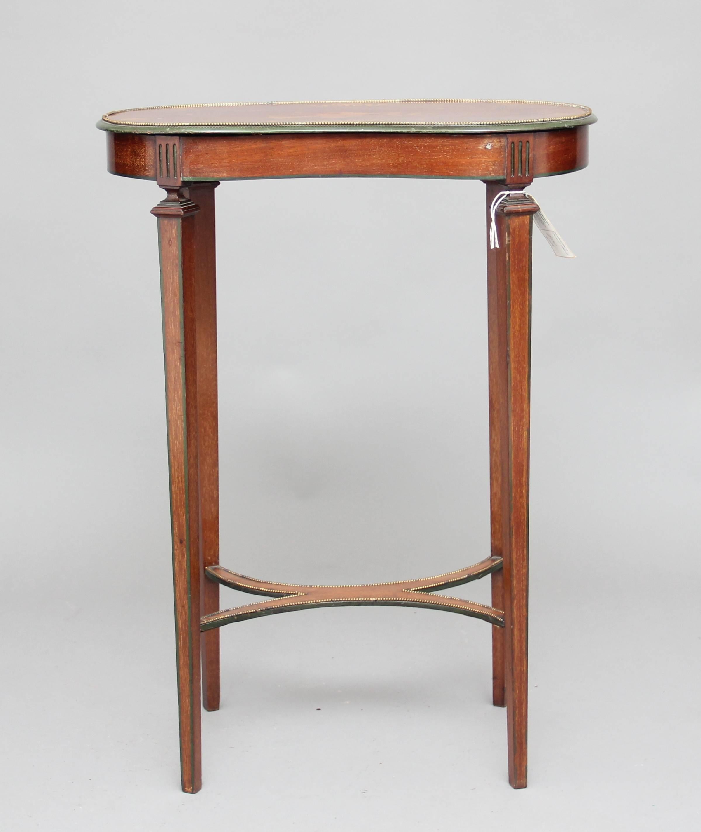 Early 20th century Edwardian kidney shaped Mahogany inlaid occasional table, the kidney shaped top inlaid with marquetry decorated with brass beading around the edge, supported on elegant square tapering legs united by a shaped stretcher, circa