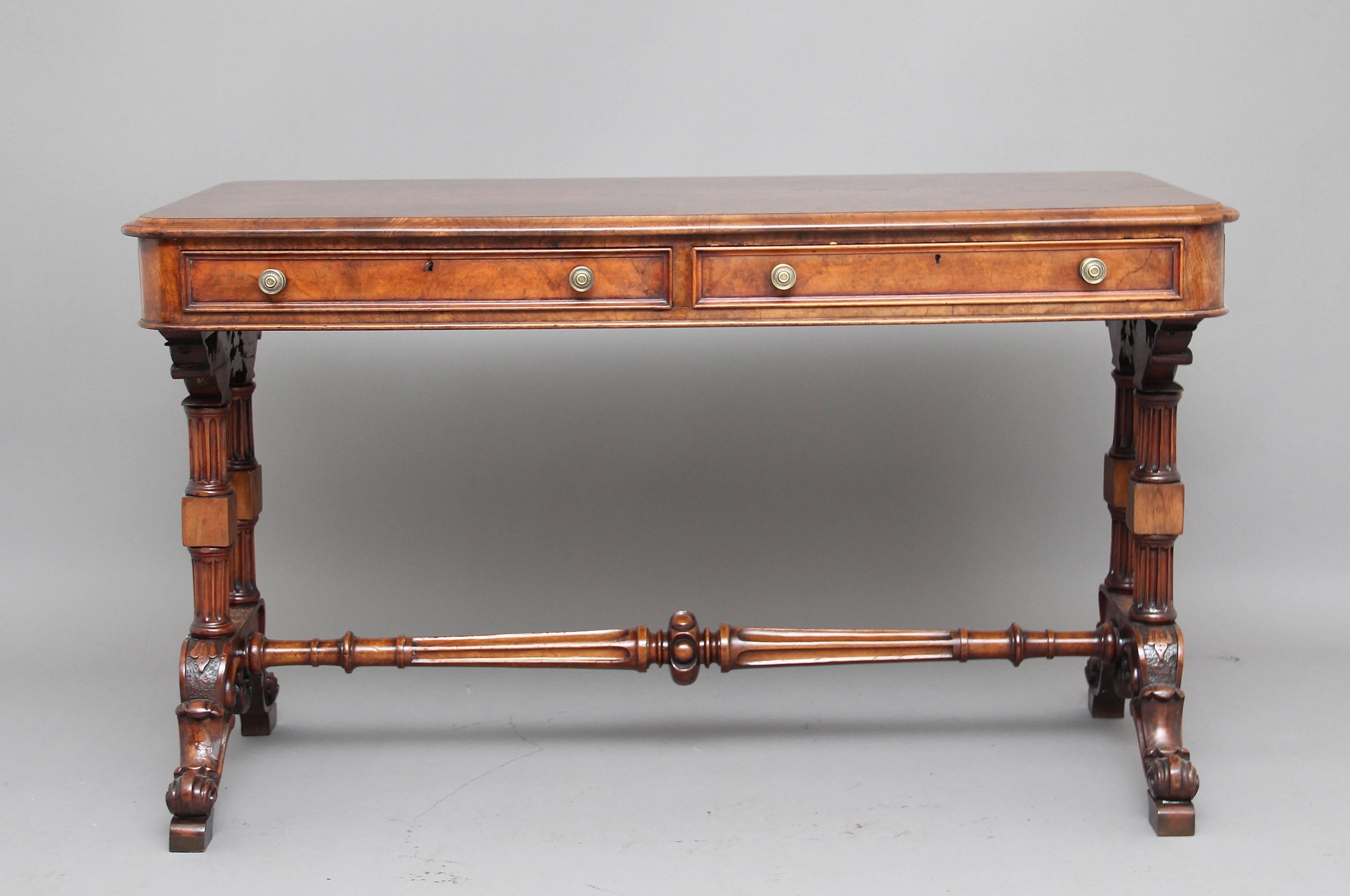 A fine quality 19th century walnut writing or sofa table with two drawers on the front and two dummy drawers on the back so the table can be freestanding in the middle of a room, the right hand drawer contains an adjustable leather writing slope