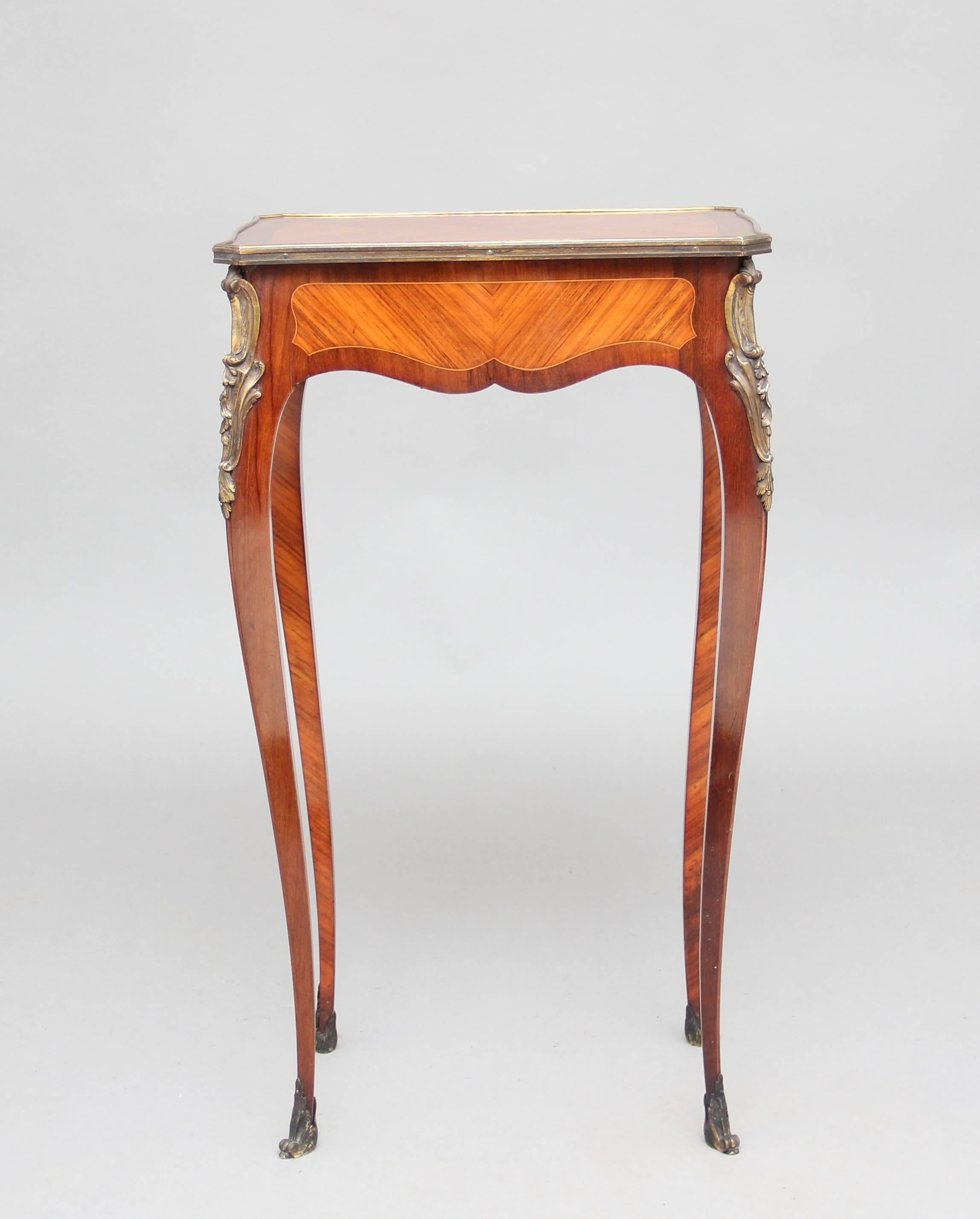 19th century French side table veneered in kingwood and tulipwood, the top is quarter veneered in kingwood of serpentine form with a brass moulding around the edge, the base has veneered panels with a single drawer in one end, to highlight the