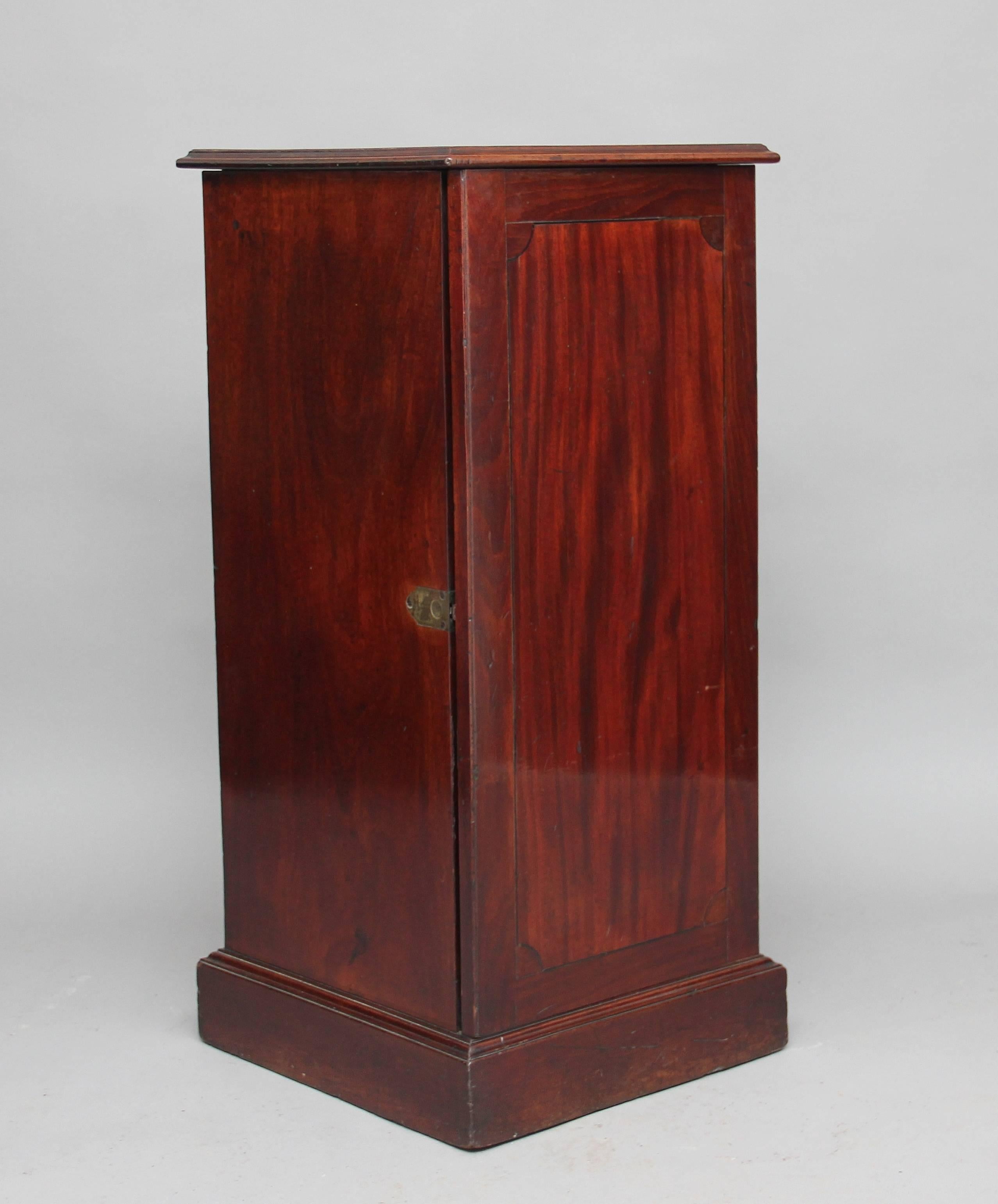 A very rare early 19th century mahogany wine cooler cabinet, the lift up hinged lid exposing a wine cooler, the door below opening to reveal a mahogany lined drawer in the centre with original brass swan neck handle and a cupboard below, circa