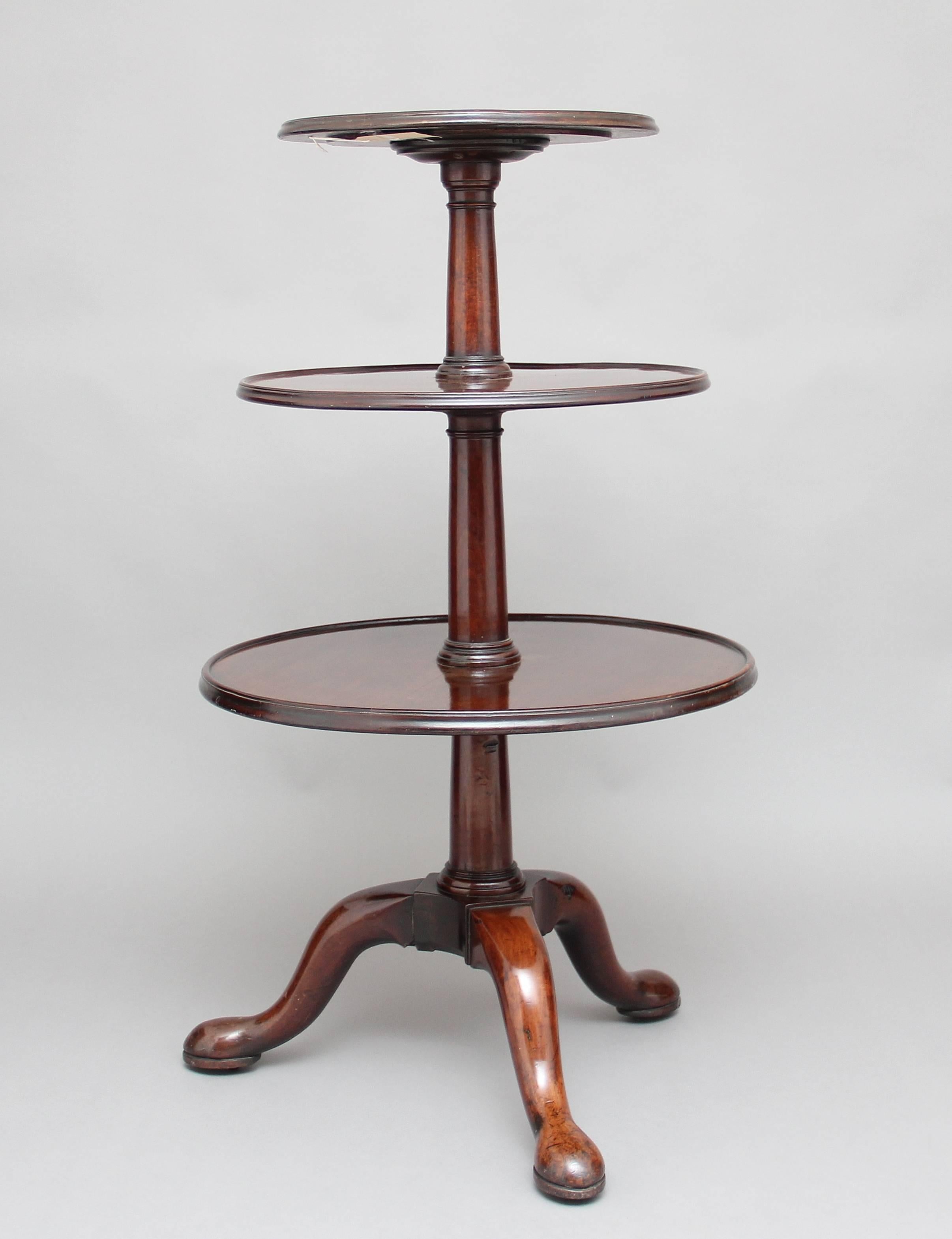 18th century mahogany three tier dumbwaiter, the elegant turned stem supporting three dish tops of various sizes standing on three cabriole legs ending with a pad foot, circa 1770.
 