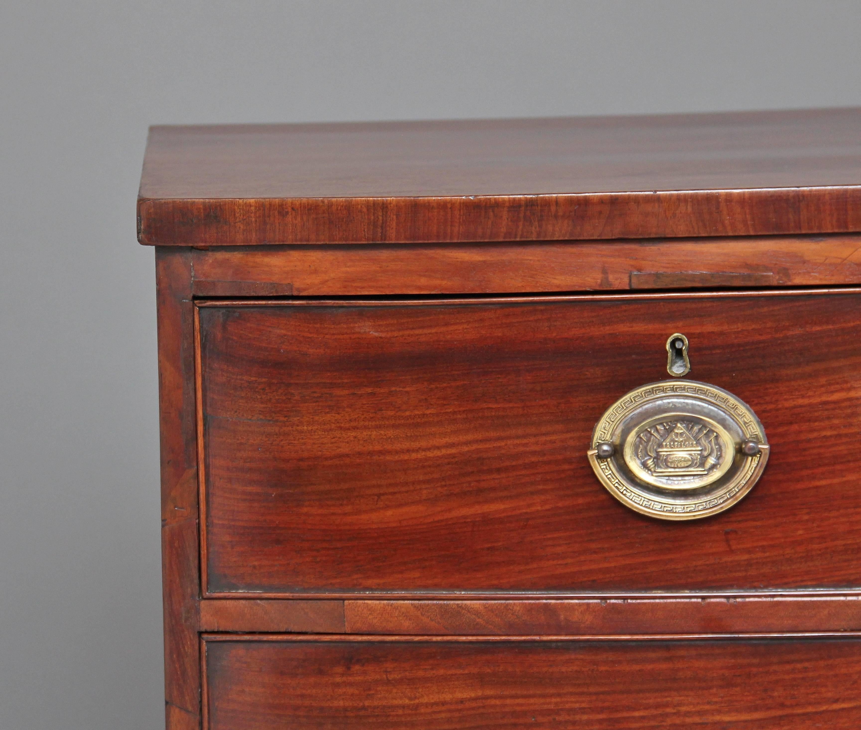 Early 19th century mahogany bowfront chest of two short over three long drawers with oval brass plate handles, standing on splay feet, circa 1820.
 