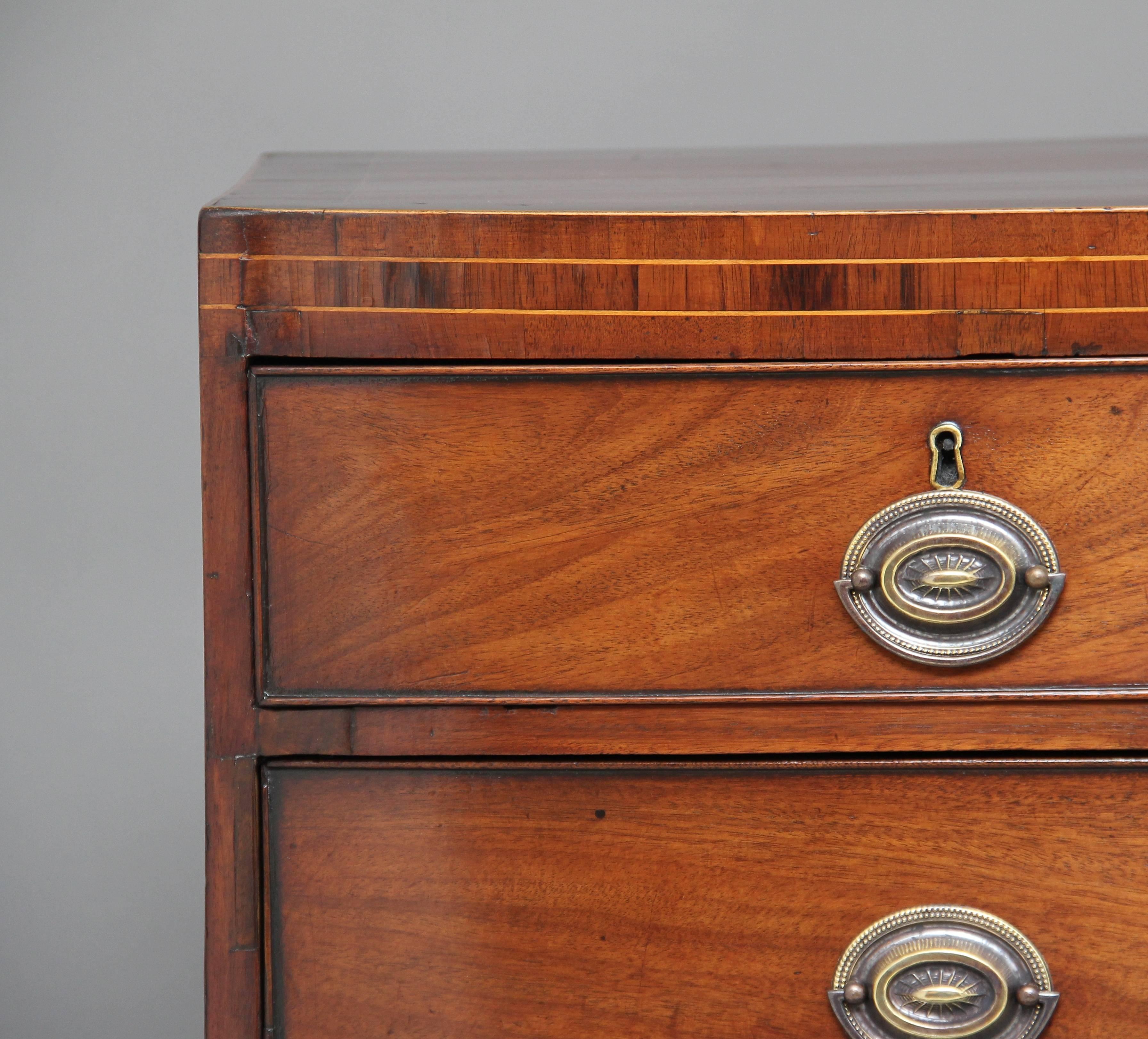 Early 19th century mahogany bowfront chest of drawers, the top decorated with boxwood inlay with two short over three long drawers below, having oval brass plate handles, standing on splay feet, circa 1810.