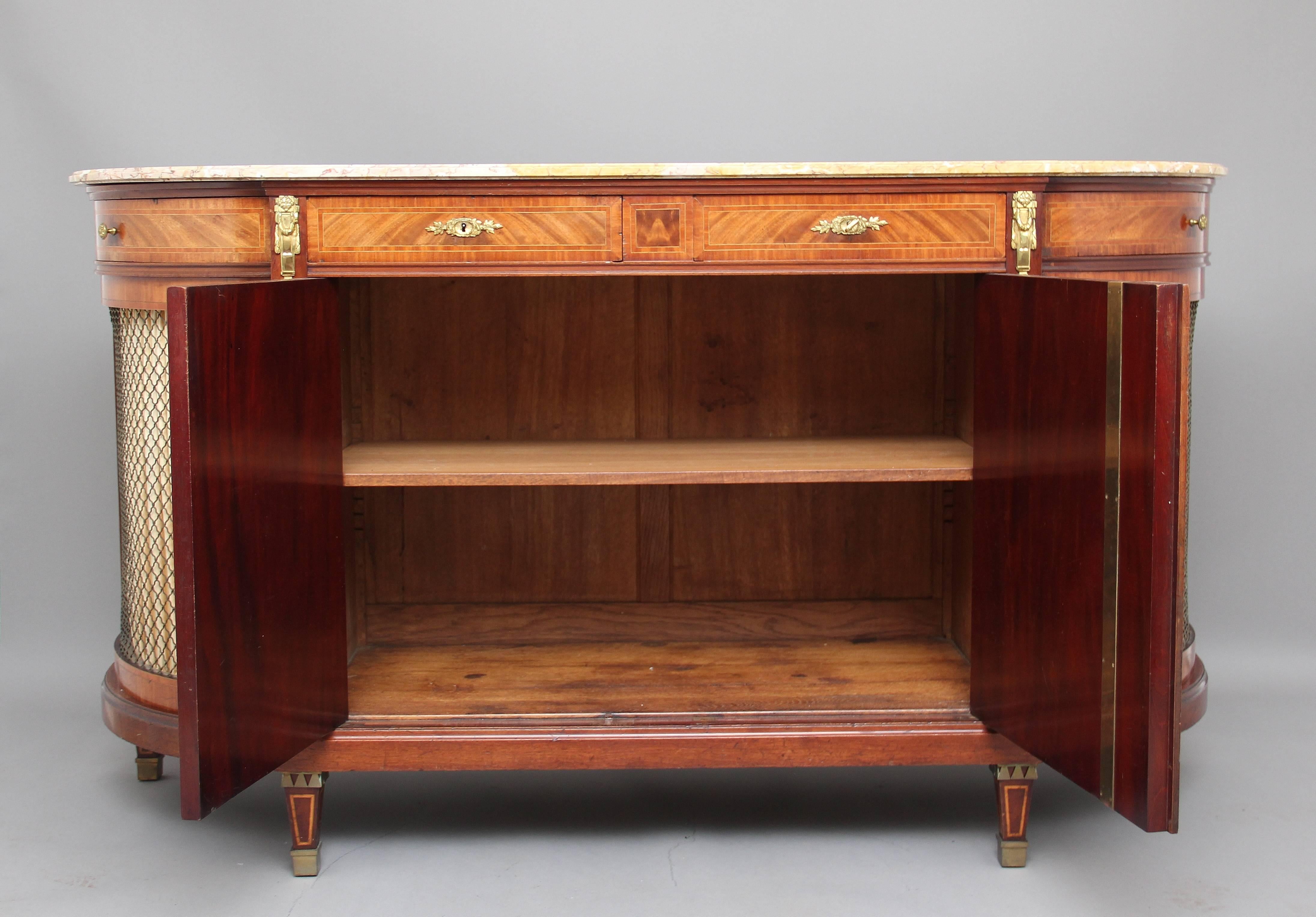 19th century French mahogany cabinet or credenza, the bow ends incorporating a drawer and a cupboard with brass grills, the centre with two drawers above a cupboard with two doors, it’s decorated with tulipwood and boxwood inlay and brass fittings,