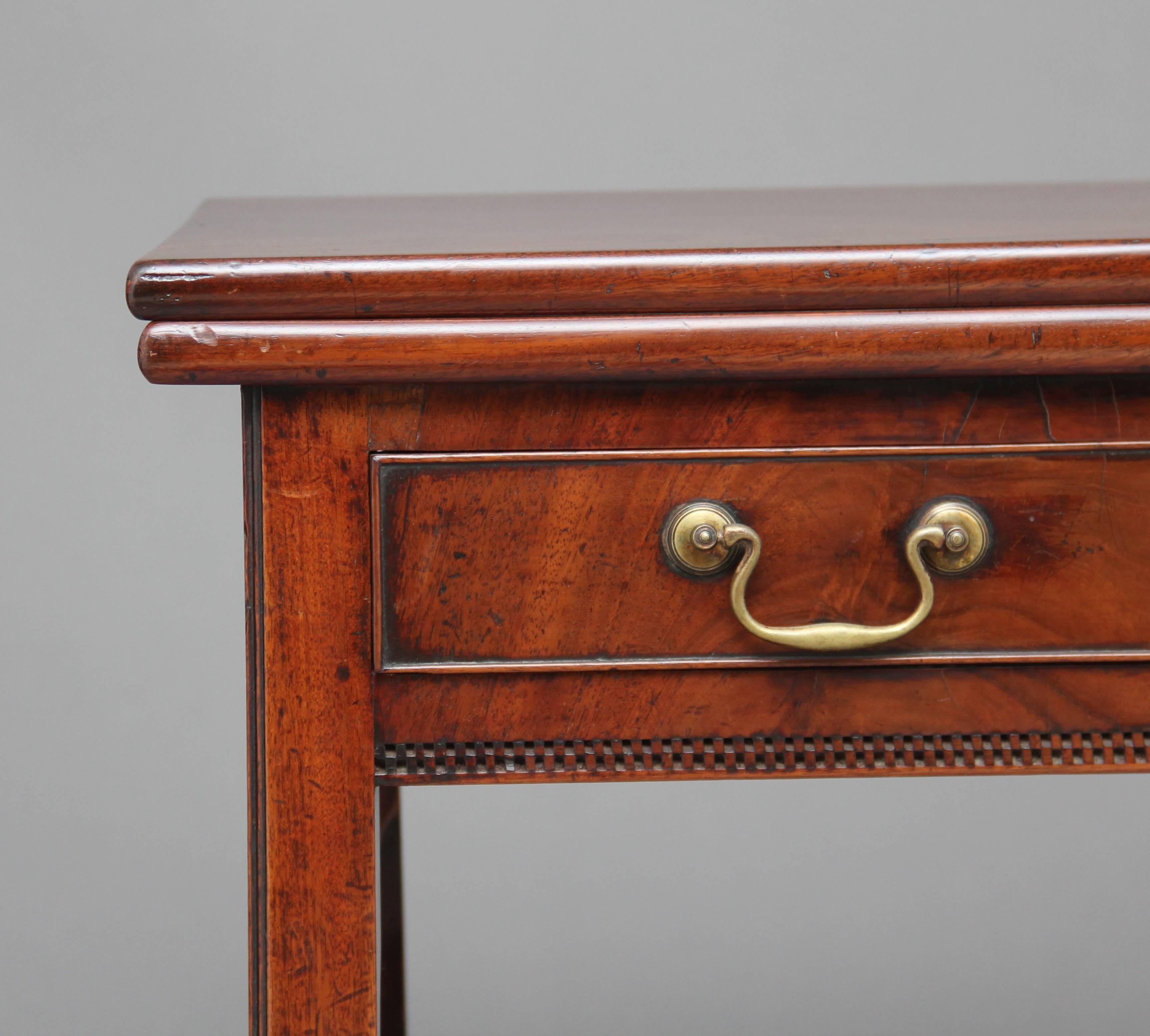 18th century mahogany tea / games table, the solid flip over rectangular top above a single oak lined drawer to the frieze with brass swan neck handles, standing on square chamfered legs, circa 1780.
 