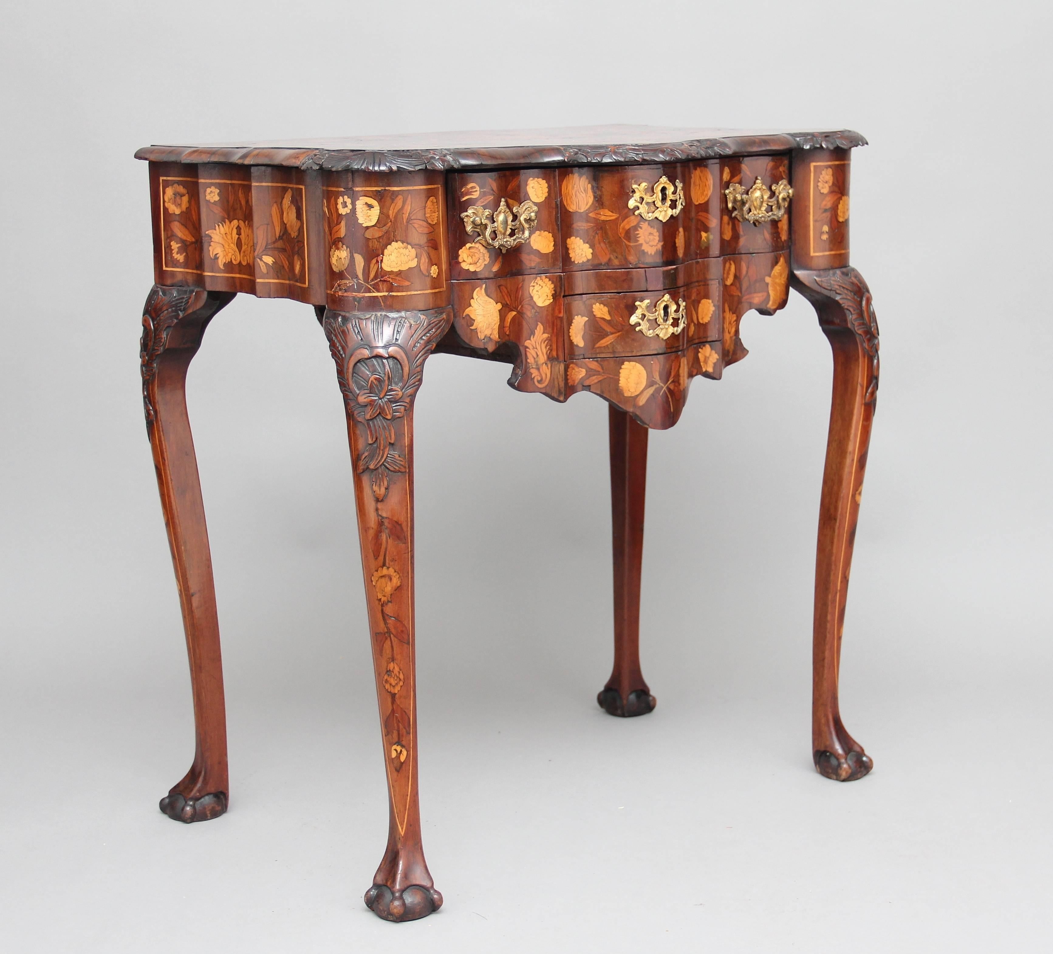 A lovely quality 18th Century walnut Dutch marquetry lowboy / side table, the shaped top profusely inlaid with various birds and floral decoration, with a carved and moulded edge above two oak lined drawers with original brass handles, serpentine
