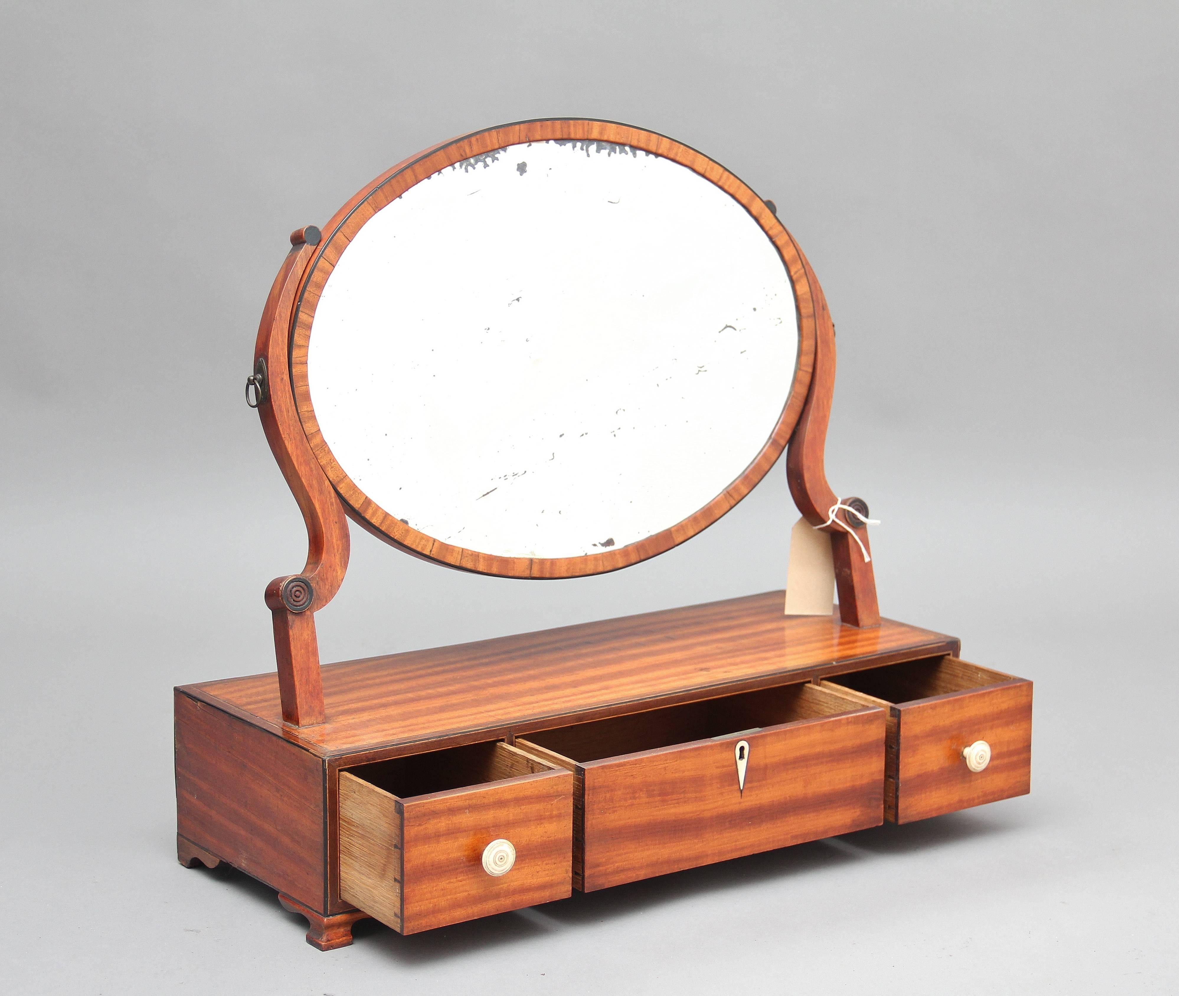 An elegant looking 19th century satinwood toilet mirror, the oval shaped swivel mirror held by shaped supports, the base section having three oak lined drawers, standing on small ogee feet, circa 1860.
 