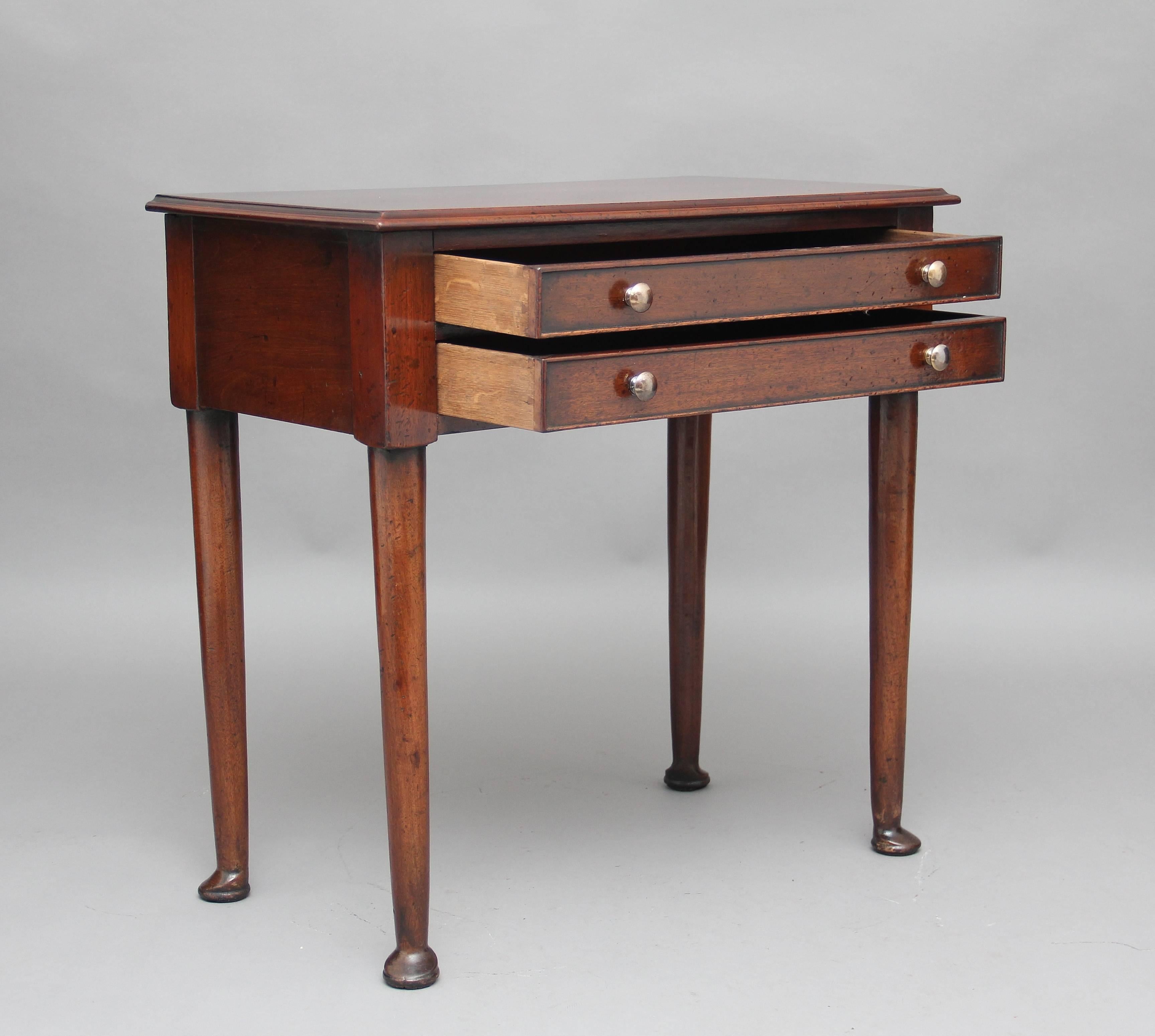 Early 20th Century mahogany side / occasional table  of nice proportions, the moulded edge top above two oak lined drawers with brass knob handles, supported on turned legs terminating on a pad foot.  Circa 1920.  

