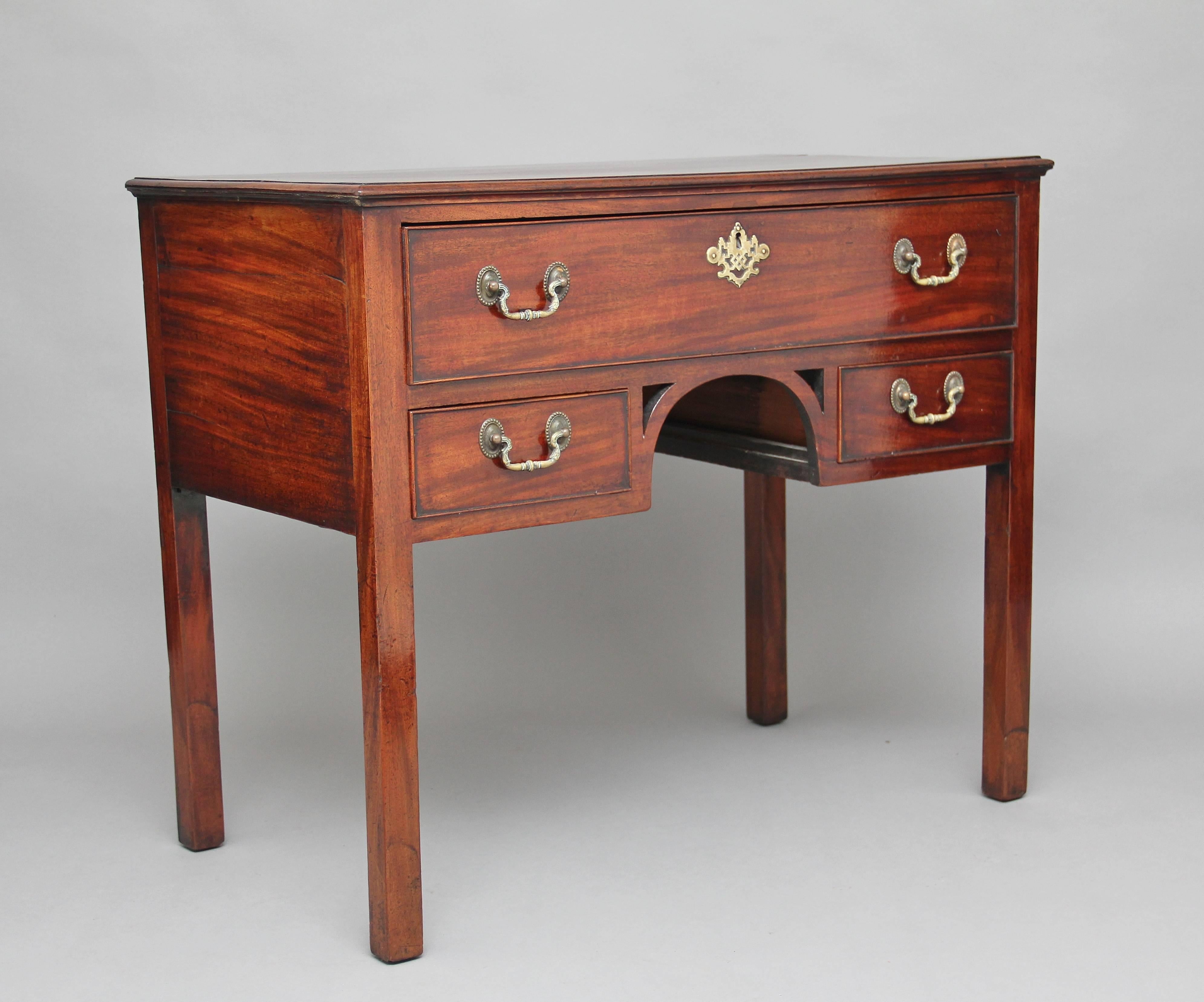 18th century mahogany lowboy or side table, the rectangular moulded edge top above a selection of three drawers with brass swan neck handles, a nice arched structure at the centre in between the bottom two drawers, supported on square legs, circa