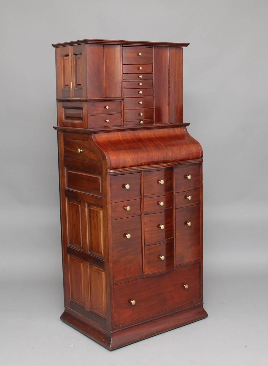 19th century mahogany dentist’s cabinet made by ”Ransom & Randolph Co, Toledo, Ohio, USA” in fantastic condition, all the original hardware, the top section consisting of various drawers, doors and secret compartments, the bottom section having a