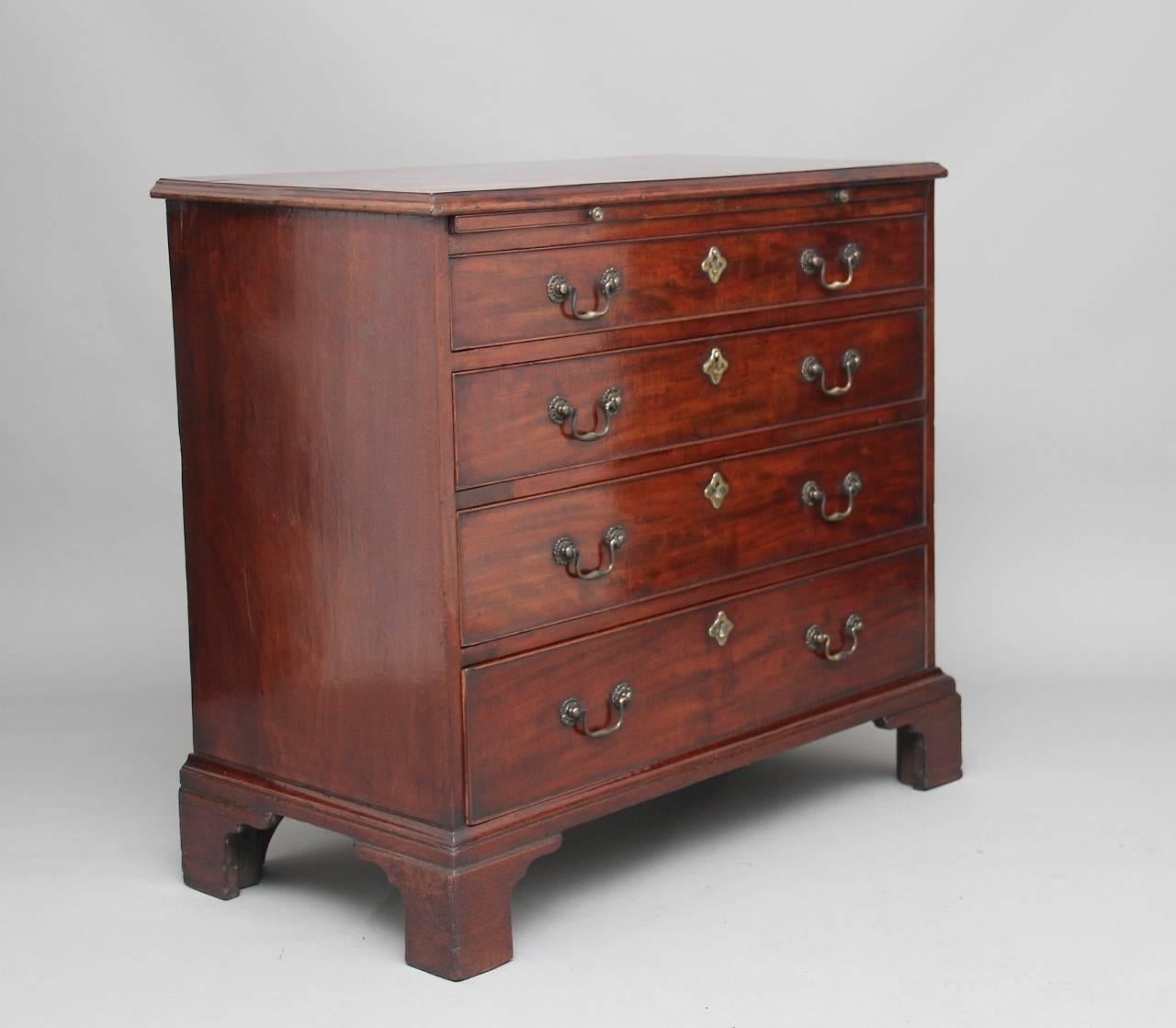 18th century mahogany Georgian flat front chest of drawers with a brushing slide, the moulded edge top above four long oak lined graduated drawers, with original ornate brass swan neck handles and escutcheons standing on bracket feet, circa 1780.
 