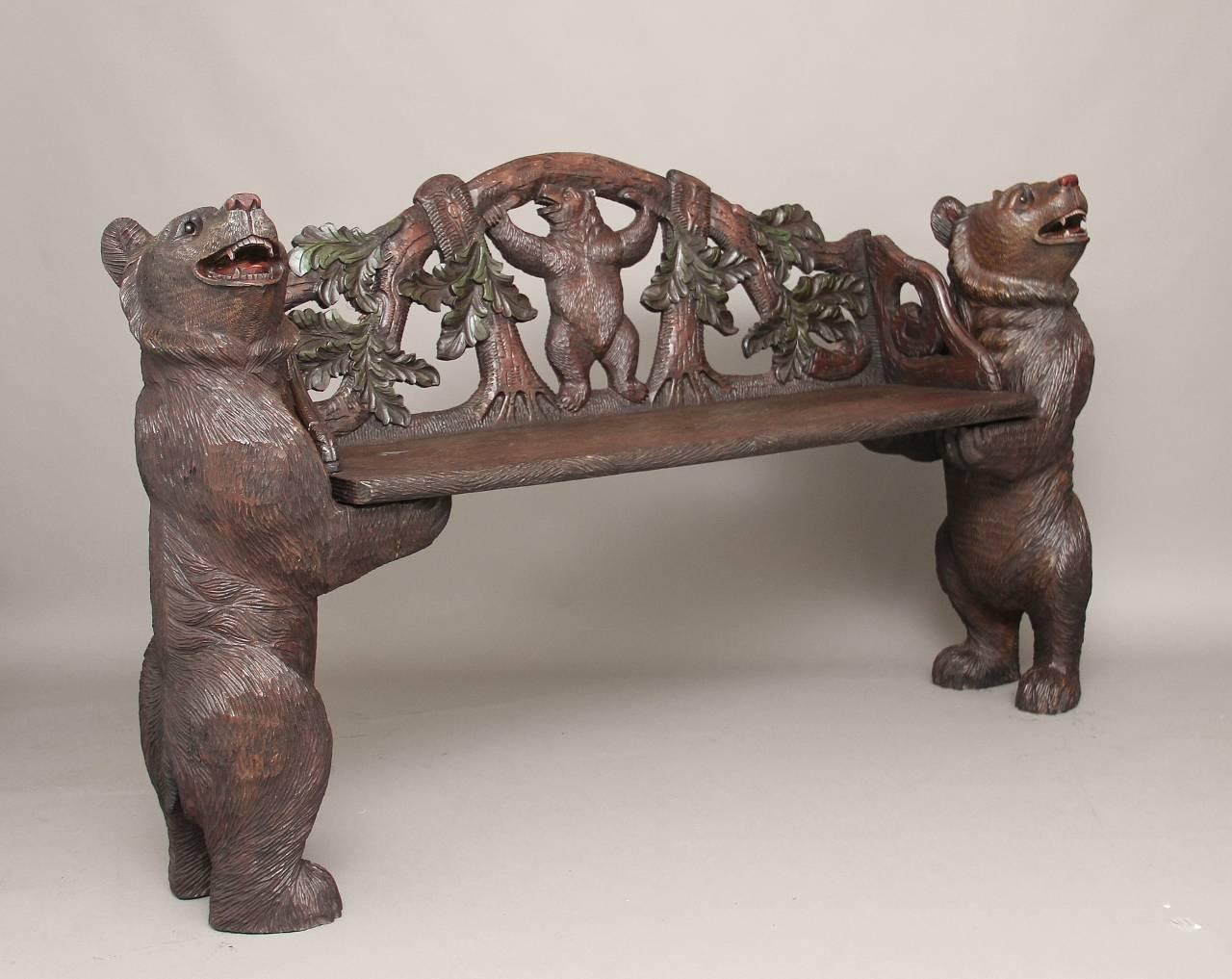 A superb quality 19th century Swiss Black Forest hall bench, the two well carved bears of good size with glass eyes supporting a carved bench with carvings of various leaves and a bear in the centre. circa 1880.