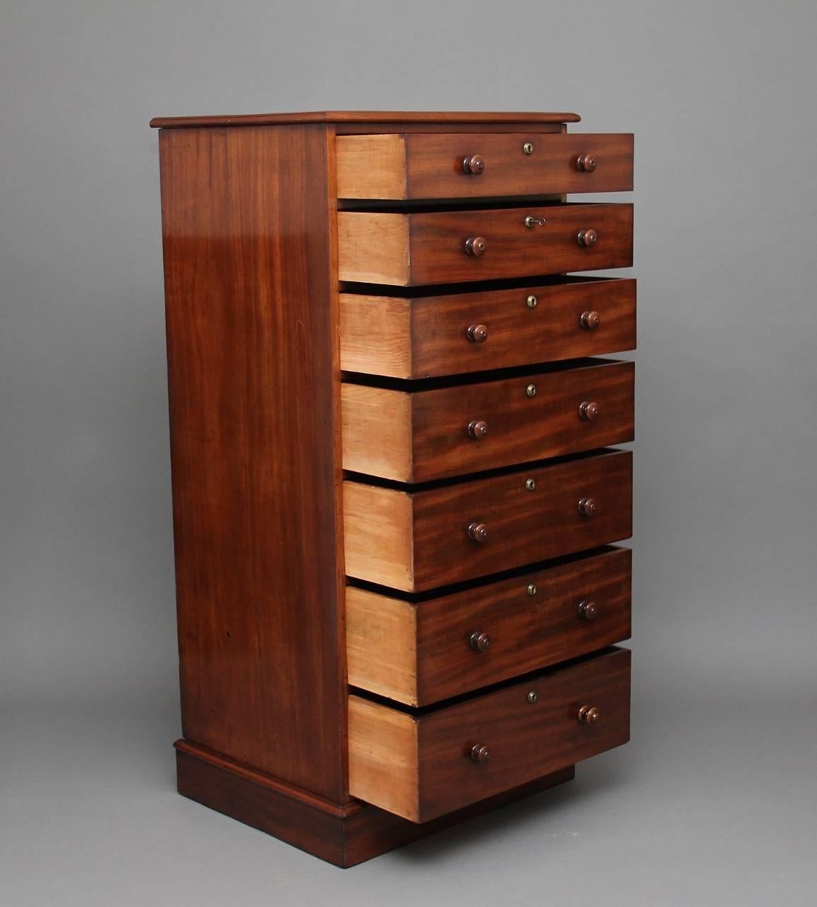 A tall 19th century mahogany chest in excellent condition, with a moulded edge top, with seven graduated drawers with original turned wooden knobs, standing on a plinth base, circa 1840.