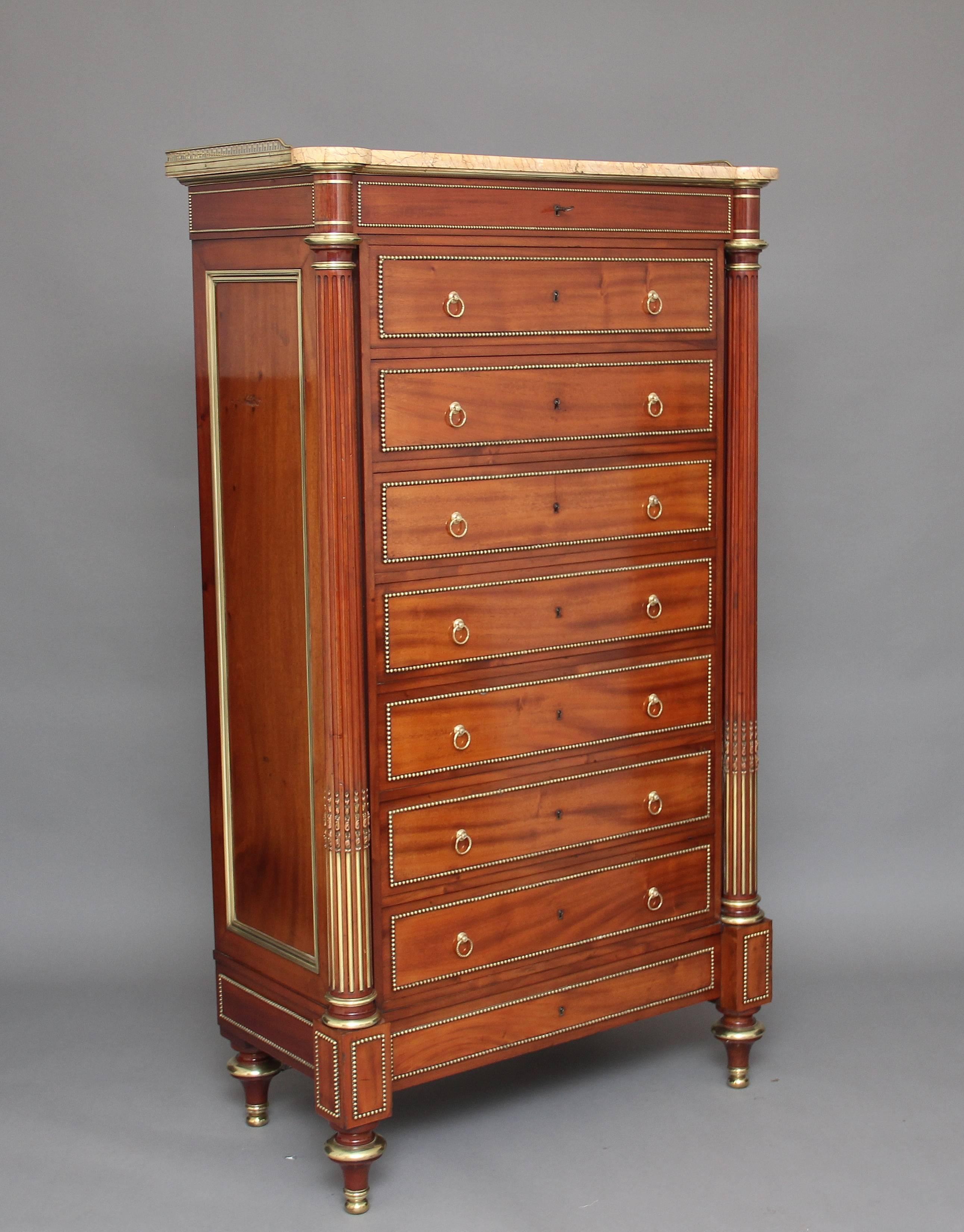 19th century, French mahogany semanier chest of exceptional quality, the chest consisting of nine oak lined drawers with original brass ring handles, flanked by wonderful fluted columns decorated with brass inserts, the original finely veined yellow