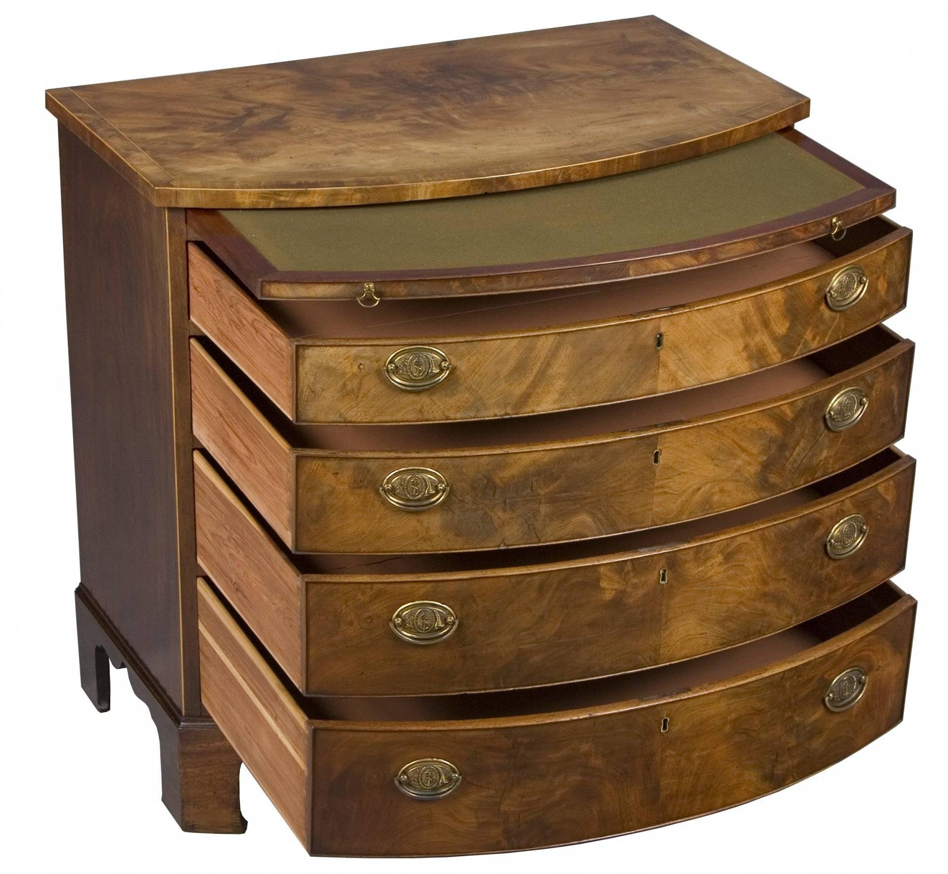 As you can see, this bow front chest of drawers comes with a brushing slide to the top. A brushing slide was originally used to lay clothes on and brush the lint off before dressing. Today, it provides a Classic look and can be used as extra space