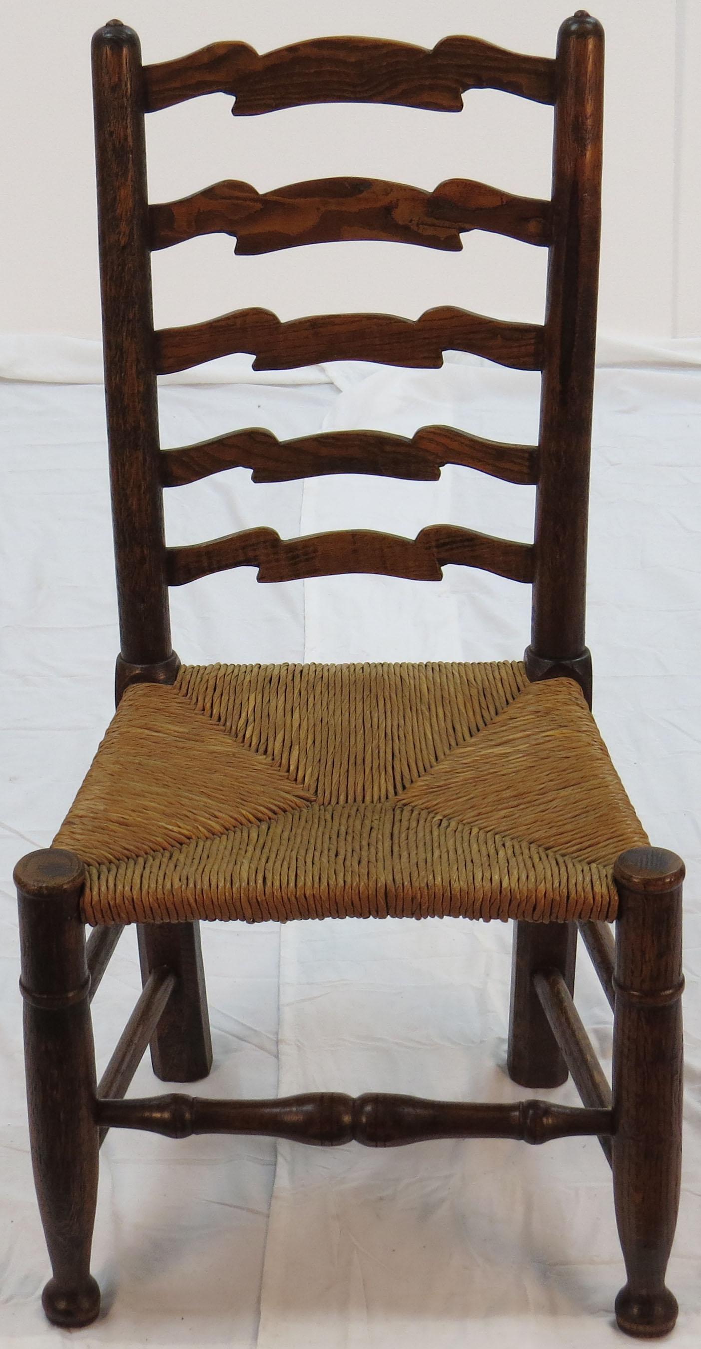 This stunning set of antique ladder back dining chairs were made of solid oak in England, circa 1940. That date technically makes them vintage rather than antique. The set consists of six chairs, none of which have arm rests.

These solid oak