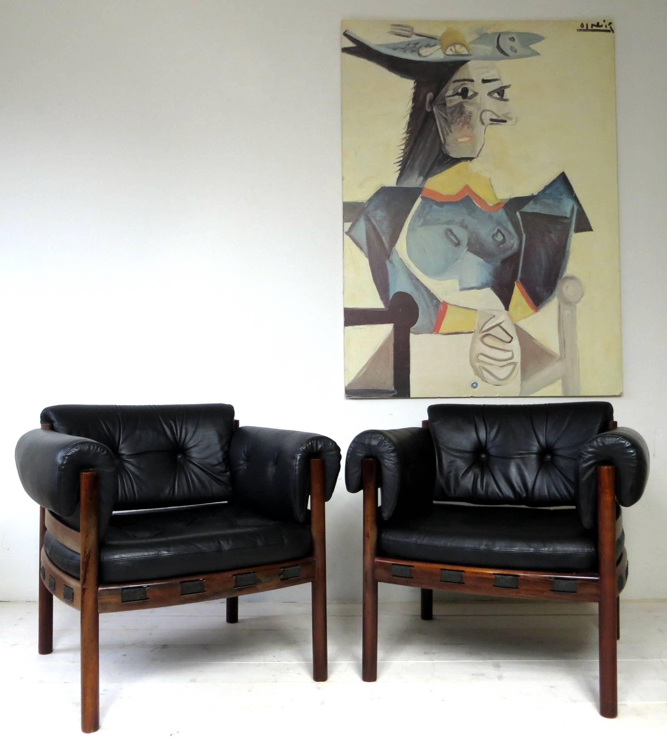 These Scandinavian modern safari armchairs designed in the early 1960s by Arne Norell for Coja . These chairs are one of the rarer design objects from Arne Norell, you will not find them often and they are rarely offered especially with the armrests