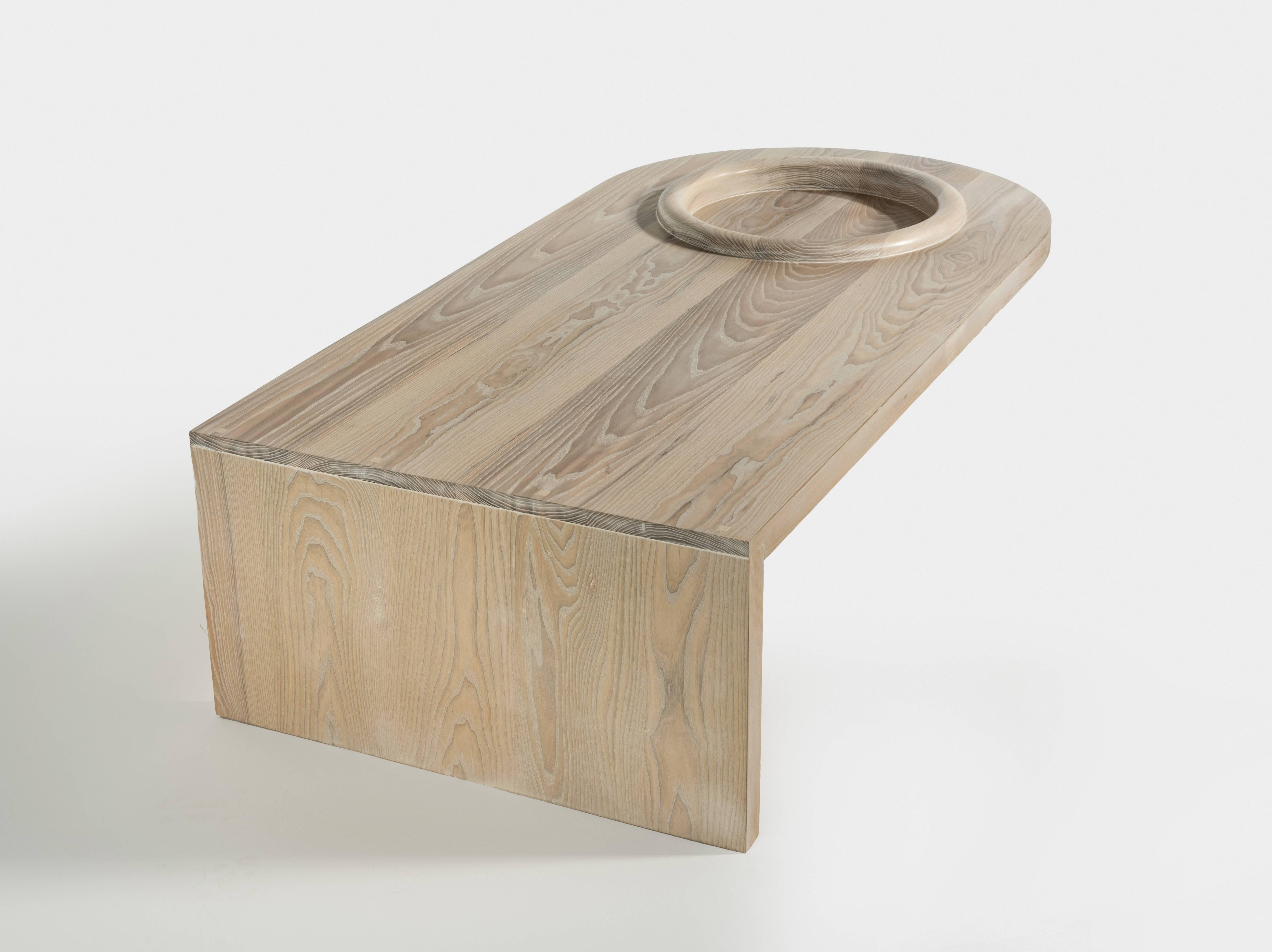 The Monolith slab takes the Monolith motif and creates a visually striking surface.

The wood of the table top has been carved away to allow the grain to roll over the rim and down into the cylinder.

All pieces can be customized in size.
 