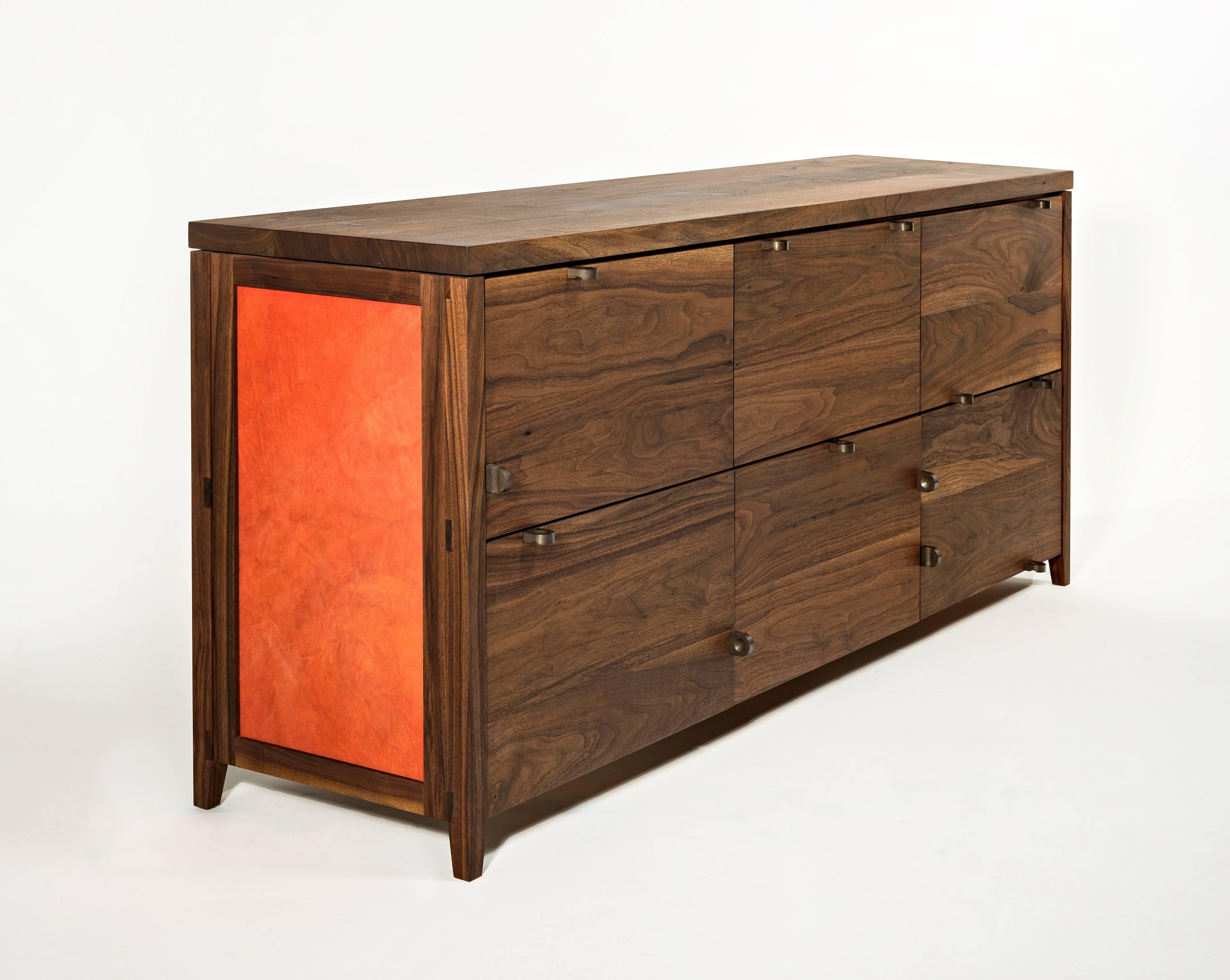 The Canvas credenza is an exploration of new materials and concepts.

The solid wood construction of the case provides moments of beautiful joinery which can be seen throughout.

The hand-dyed canvas panels provide a natural inconsistency that