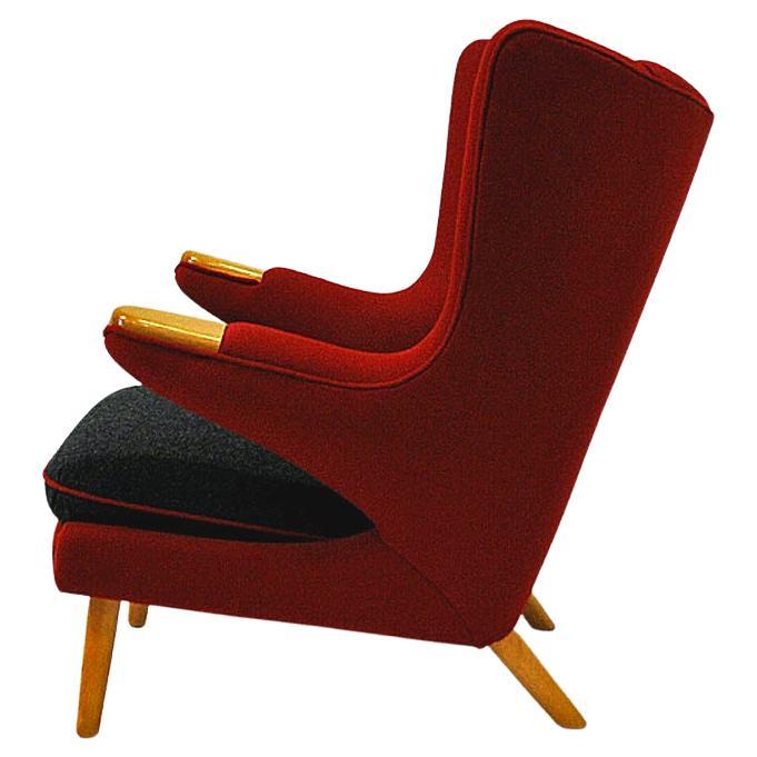 Lovely and comfortable mid-century Wing Back chair reupholstered in a beautiful red and black Norwegian Hallingdal wool fabric designed by Danish designer Nanna Ditzel. 
This vintage chair is from around the 1950s and is similar to the 'Papa Bear'