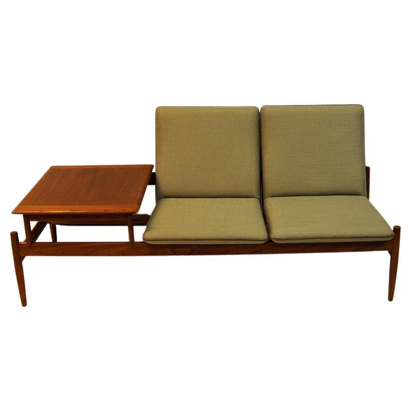Special and rare midcentury sofa set named Saga- including a teaktable that can be removed and placed where you wish. New upholstery in beige soft fabric. Leather piping around the seatedges. Teaklegs and trunk. This set is designed by Gunnar Sørlie