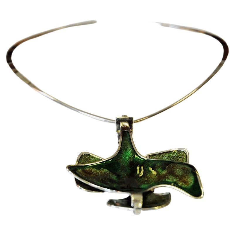 The most beautiful necklace ever!
Silver neck ring with a lovely green enamel pendant. The pendant is made with a mirror enamel technic and gives a great shine to it consisting of a double layer design and it can be worn in two ways (reversible).