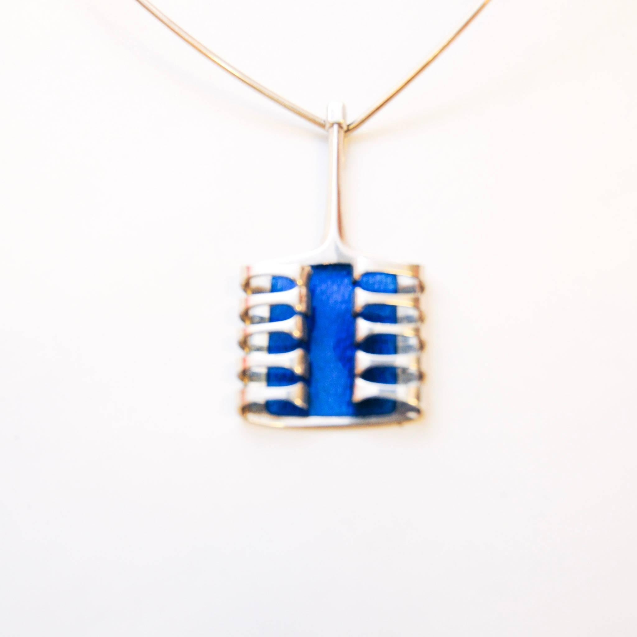 Silver Harp pendant with blue enamel designed by Bjørn Sigurd Østern (1935-). Produced by David Andersen. 1966. Width: 3,5 cm. depth: 0,9 cm. height: 6,5 cm. Stamp on backside: 