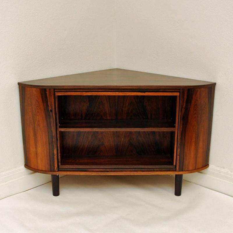 Corner rosewood bar cabinet with hidden shelves behind the glass front bar. Turn around the bar and you will have nice shelves to put your books, magazines, hidden secrets etc. From around the 1960s. Materials: rosewood and glass/mirror. Measures:
