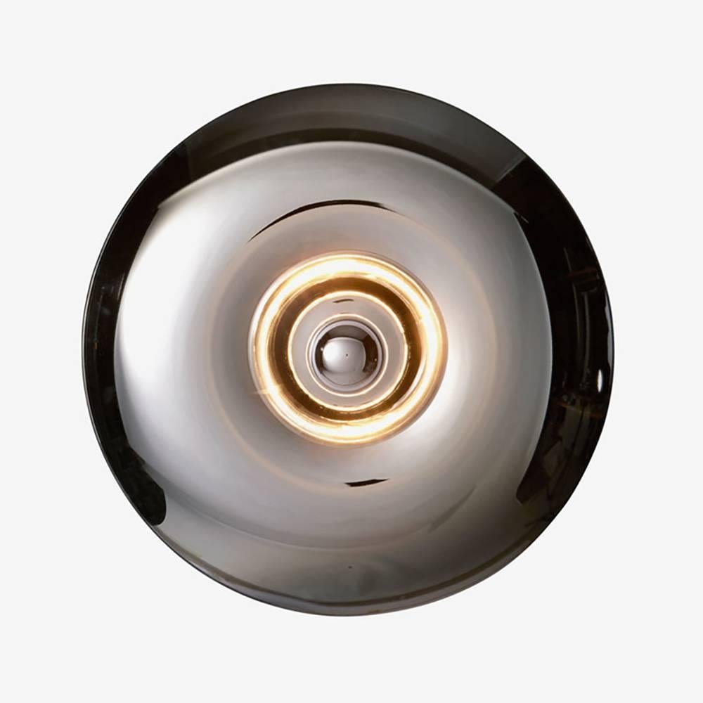 Gold thermoformed glass (also available in silver) mounted on a base available in lacquered black metal.
Can be used as a wall or ceiling light.
Made by hand in Europe.
   