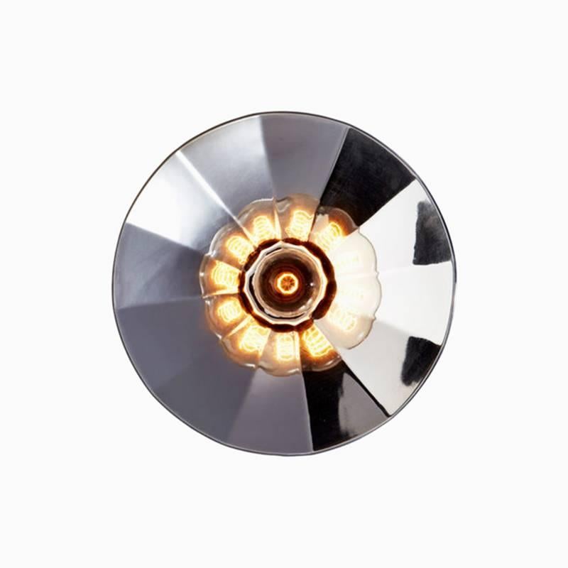 Gold thermoformed glass (also available in silver) mounted on a base available in lacquered black metal or solid oak.
Can be used as a wall or ceiling light.
Handmade in Europe 

Available in two sizes:
Large 27.6 in. diameter x 5.9 in. deep
Medium