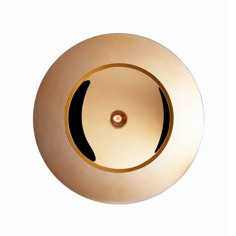 Gold Thermoformed glass (also available in Silver) mounted on a base available in lacquered black metal or solid oak. 
Can be used as a wall or ceiling light.
Made by hand in Europe.