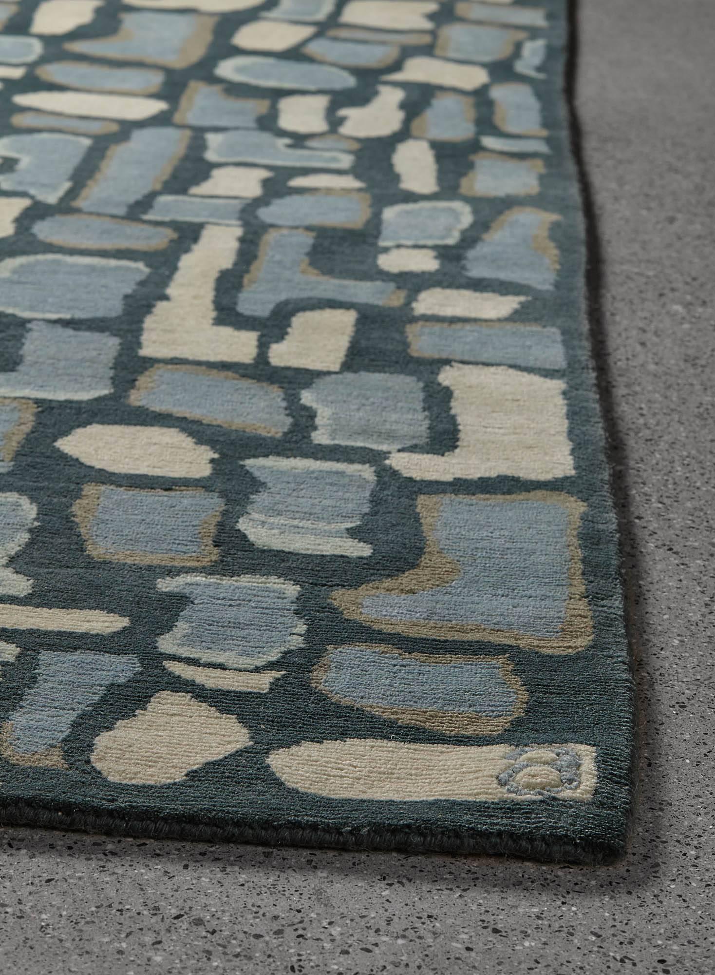 Composites of the simplest elements make up some of the greatest wonders of the natural world. The Pyrite / Toopaz area rug from Angela Adams combines simple, colorful, organic shapes in blue and grey to create a textural landscape. Hand-knotted