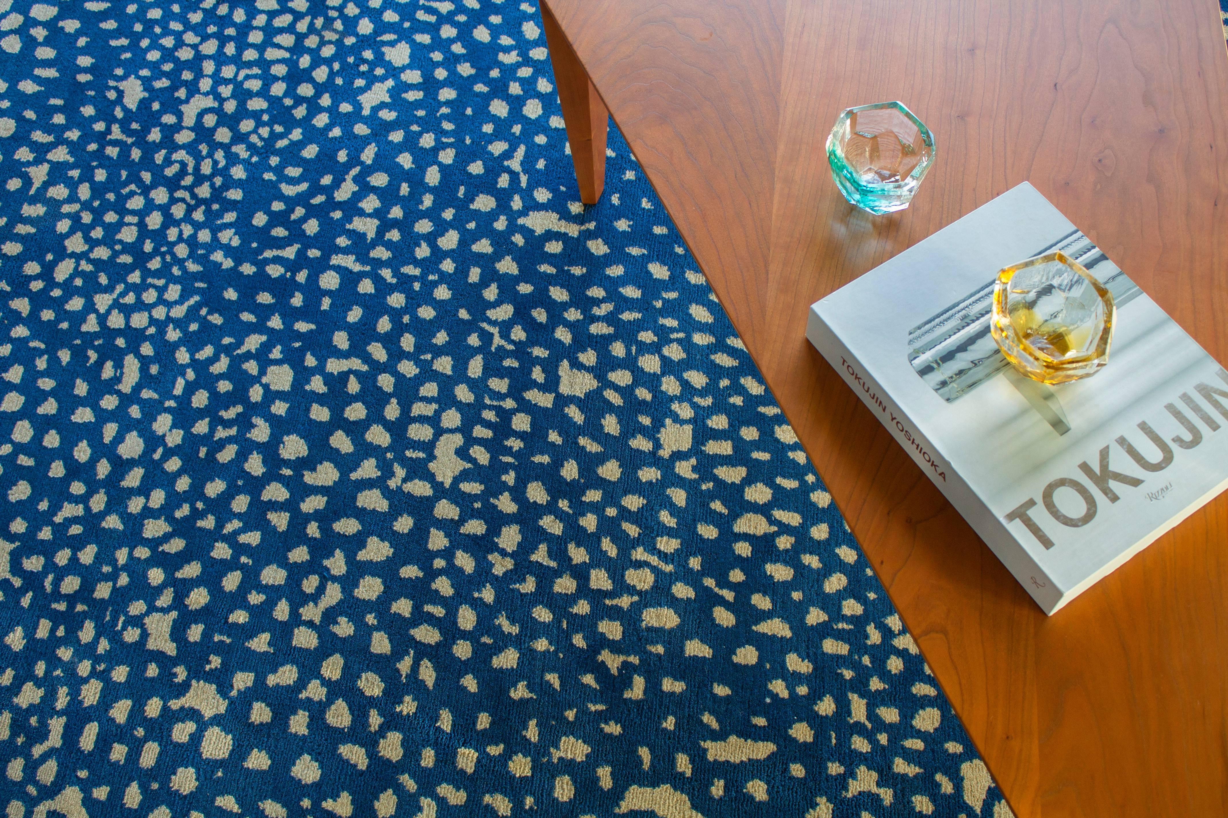 Vast as the night sky, the chaos of the Starry or Sapphire pattern resolves into a calming and expansive design, combining simple and organic circular shapes in brilliant blue and natural. Hand-knotted with 100% New Zealand wool, every Angela Adams
