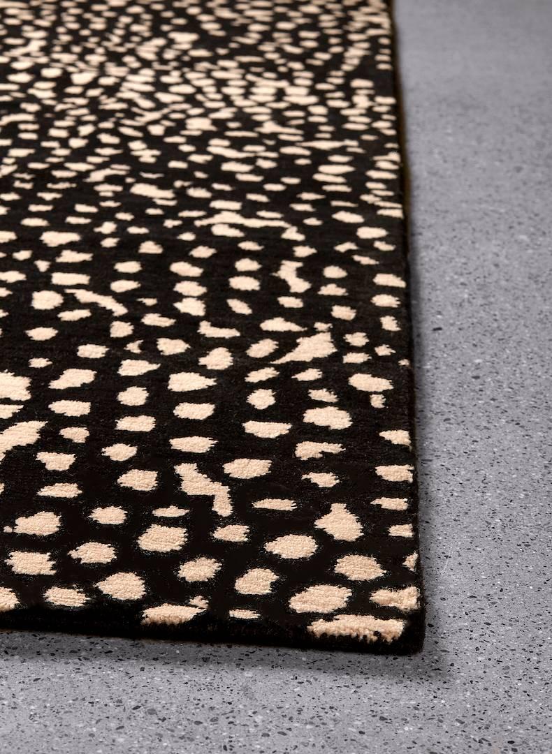 Vast as the night sky, the chaos of the Starry / Onyx pattern resolves into a calming and expansive design, combining simple and organic circular shapes in rich black and natural. Hand-knotted with 100% New Zealand wool, every Angela Adams area rug