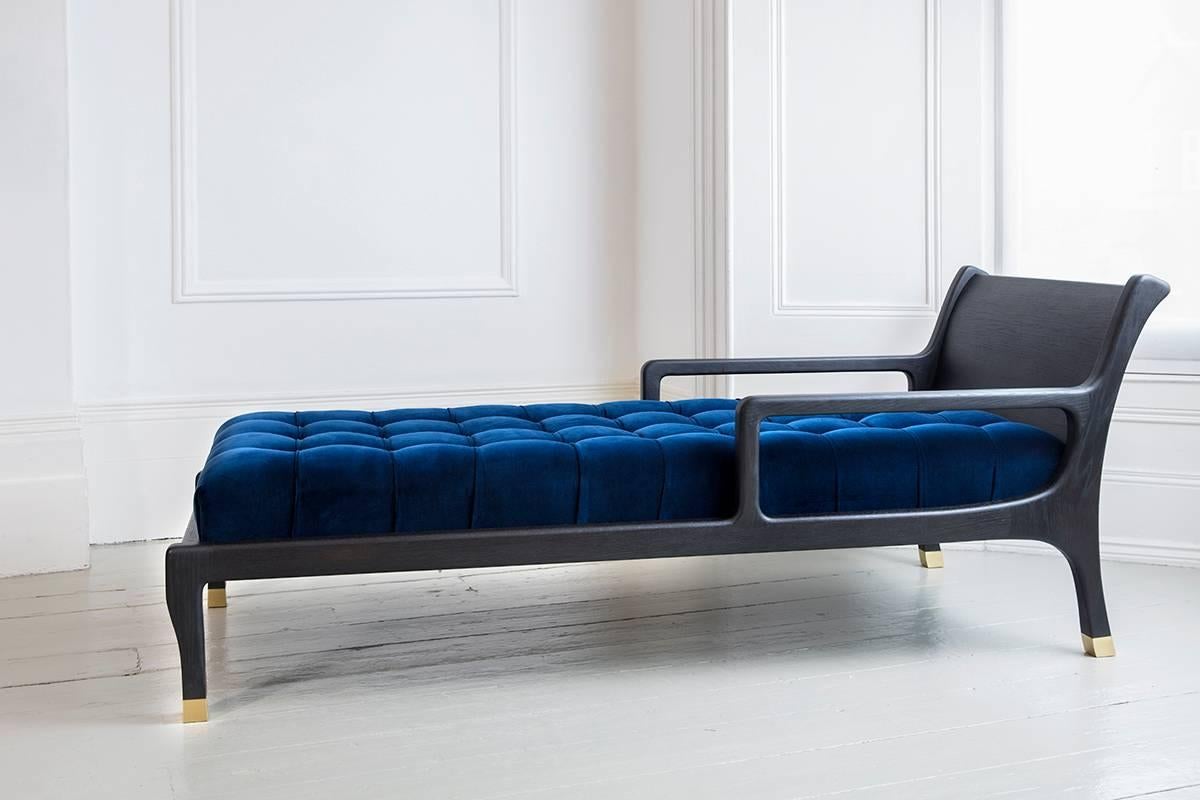 A stunning combination hand-carved chaise longue with a hand applied blackened oak frame, upholstered in cotton velvet, solid brass socks. This unique piece oozes timeless elegance.