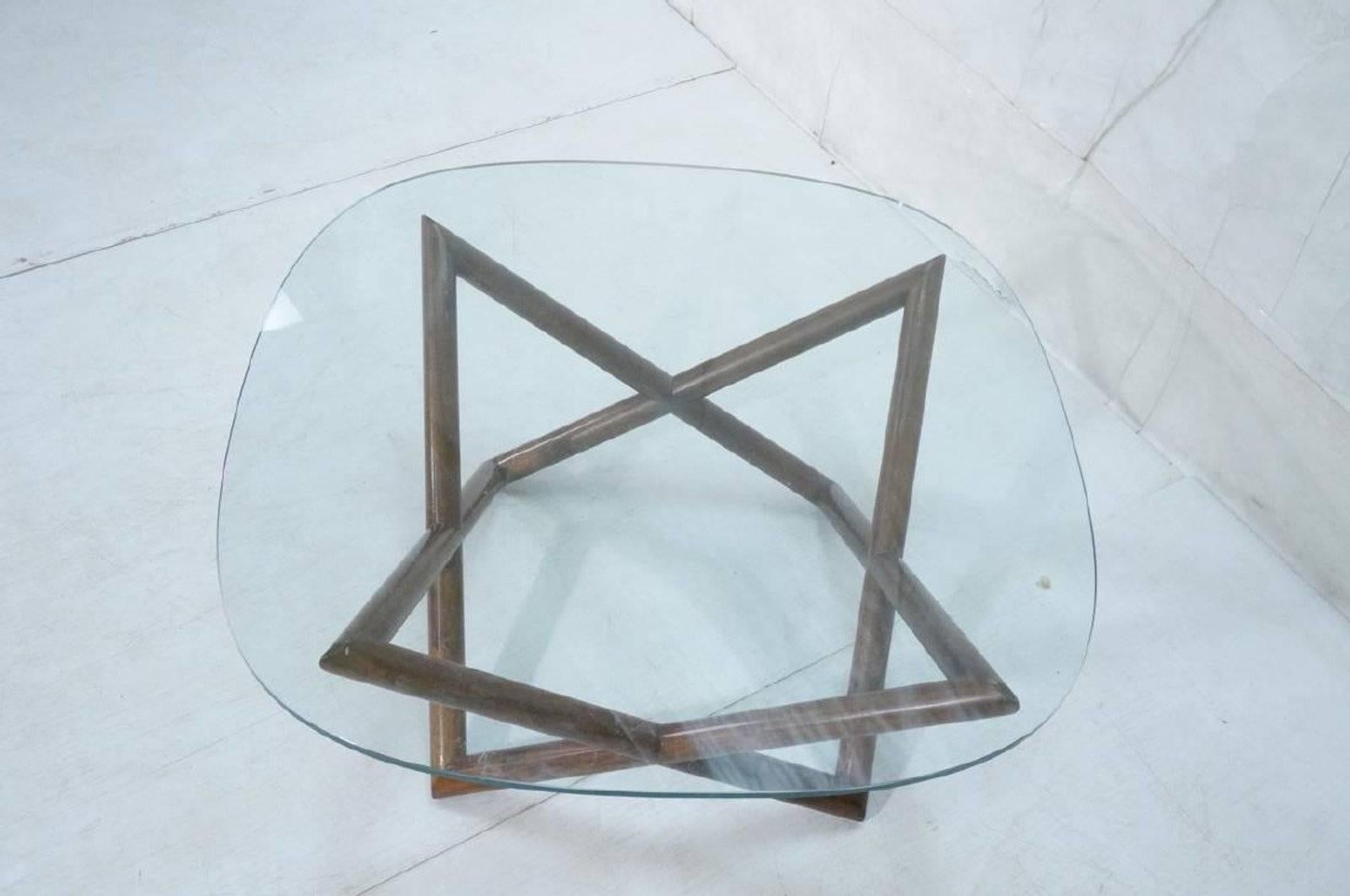 This modern walnut base cocktail / coffee table is a modern classic. The open pointed star base is solid walnut and comes with a simple rounded square glass top.

Dimensions: 16.25