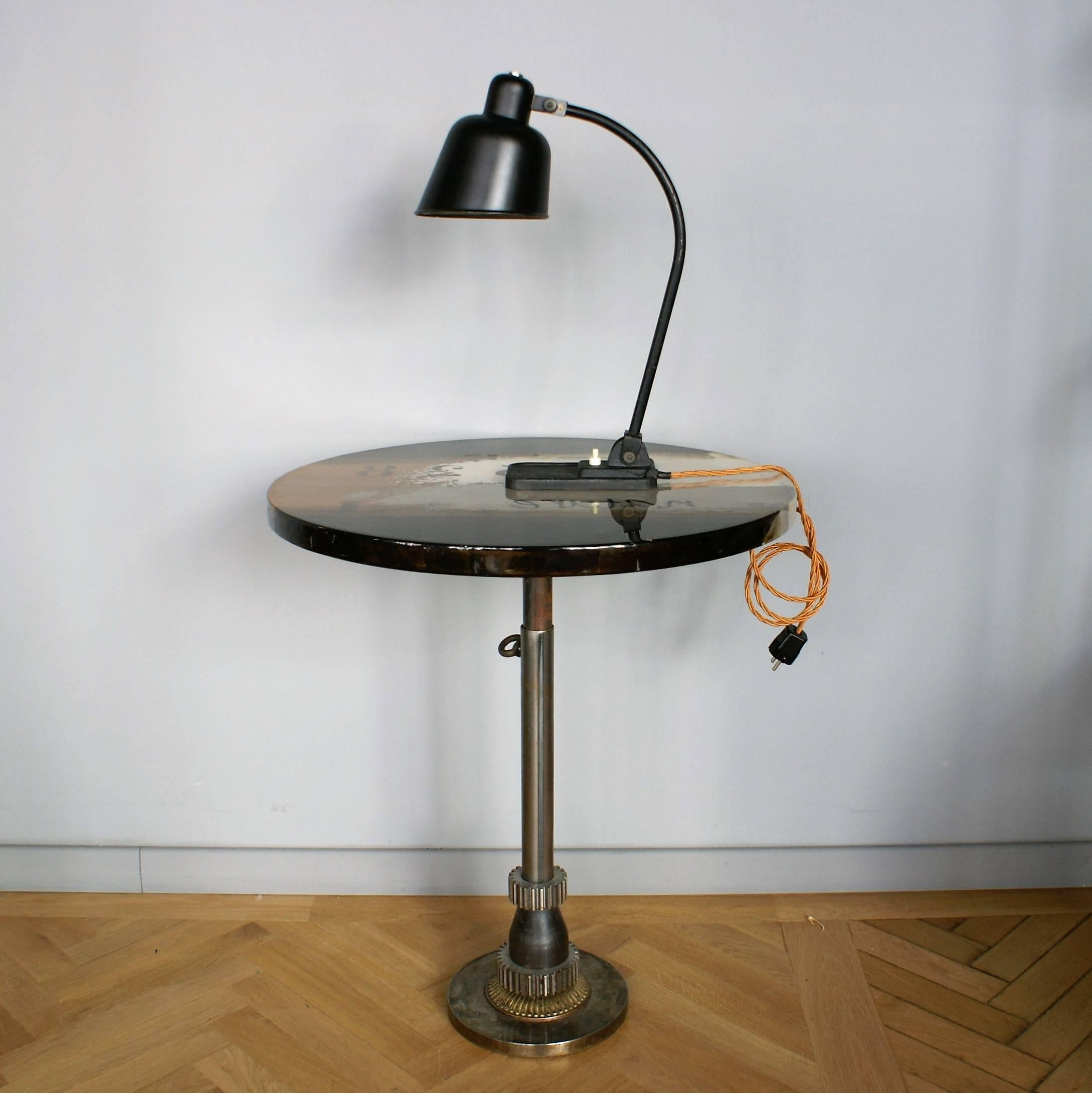 Iconic Bauhaus desk lamp designed by Christian Dell in original condition.
Adjustable arched tubular steel stem and an adjustable black lacquered alloy lamp shade.

Staatliches Bauhaus, commonly known simply as Bauhaus, was founded by Walter