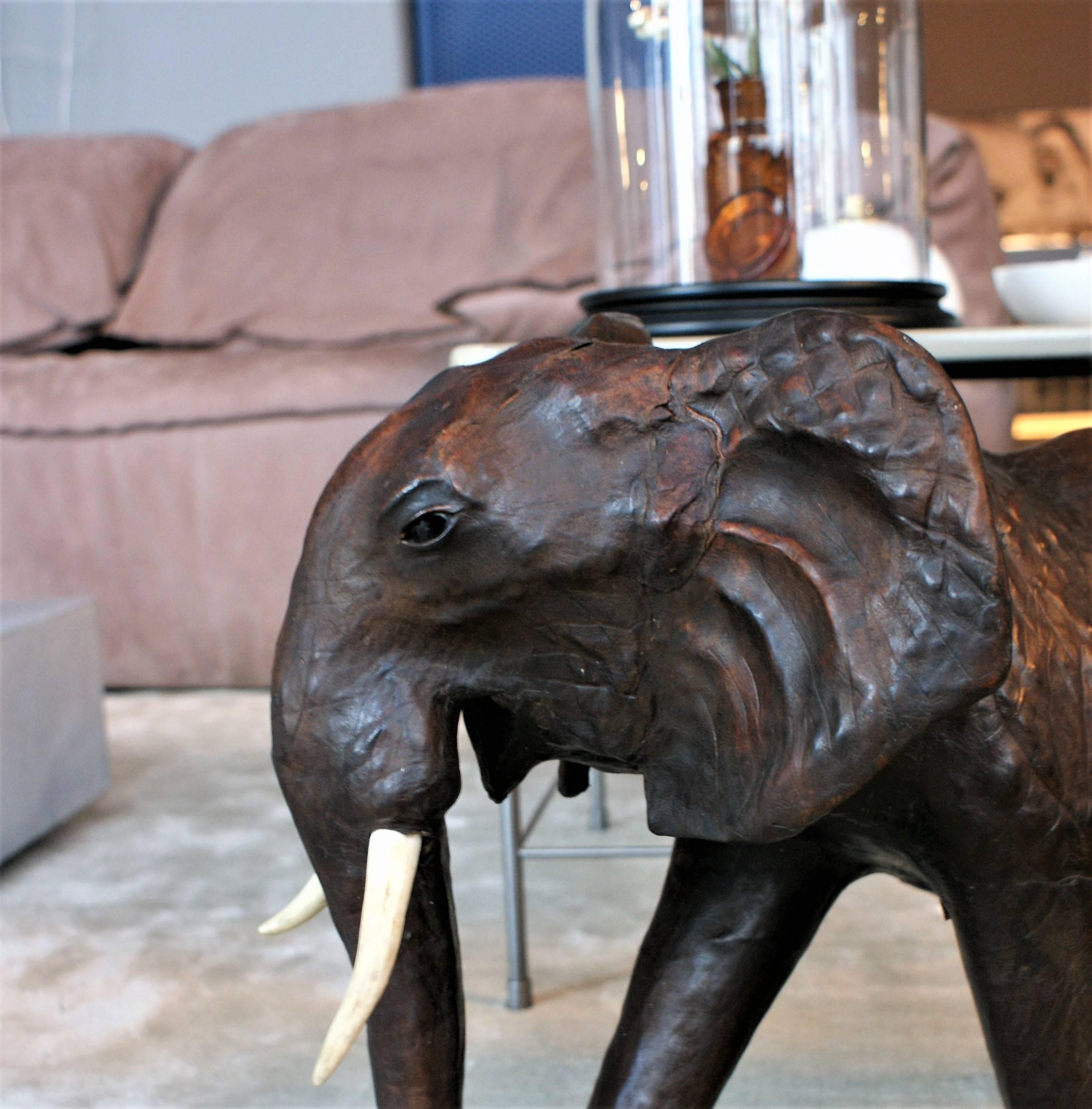 Large brown real leather elephant with an amazing patina. Great handmade object from late 1950s with real bone tusks and glass eyes. 

Design Period: 1950-1960 
Year of Production: late 1950s
Country of Manufacture: UK 
Detailed Condition: Very Good